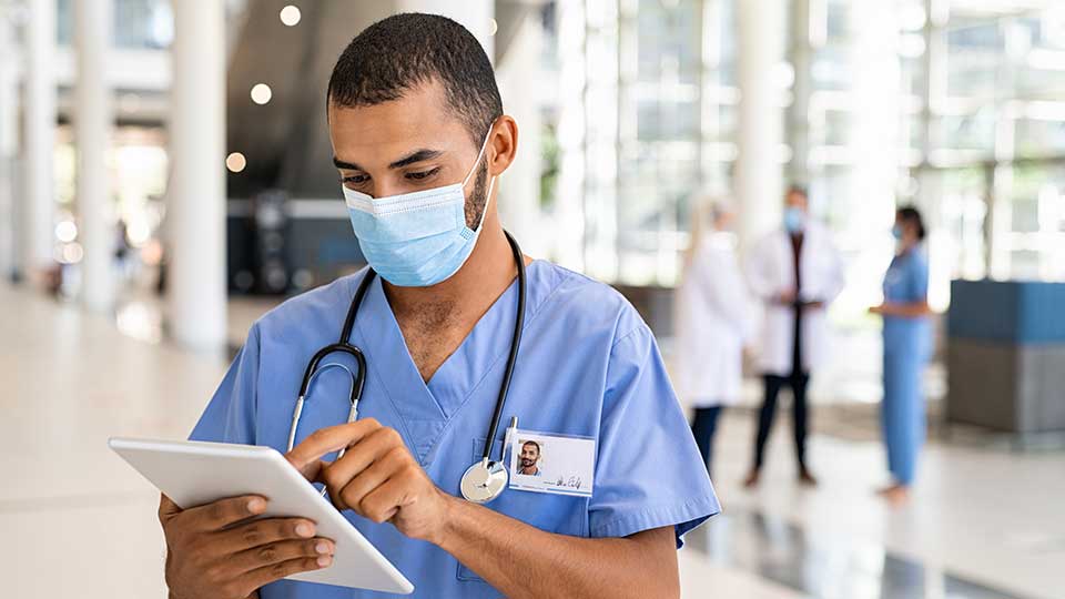 nurse checking tablet