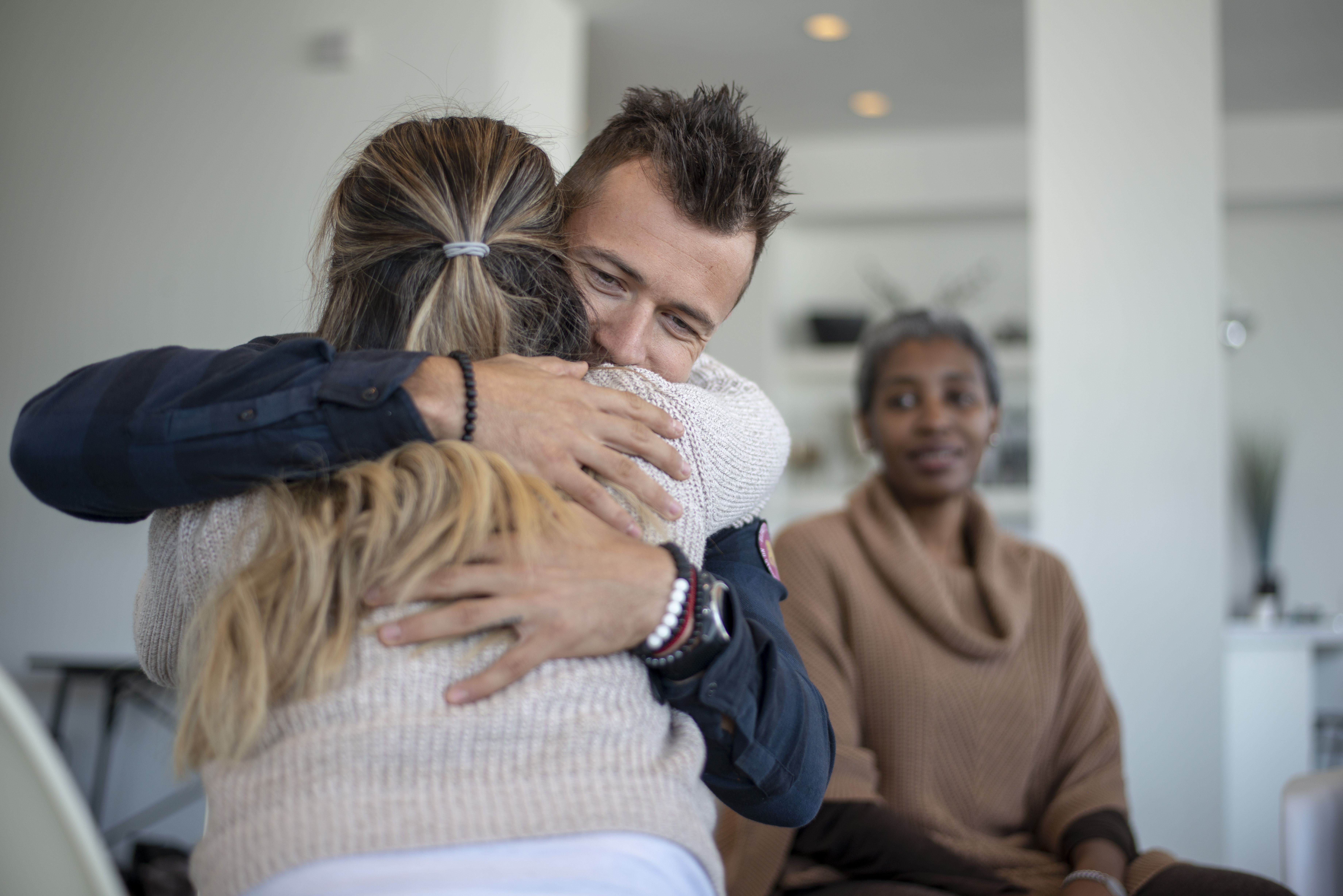 Members of a therapy group hugging