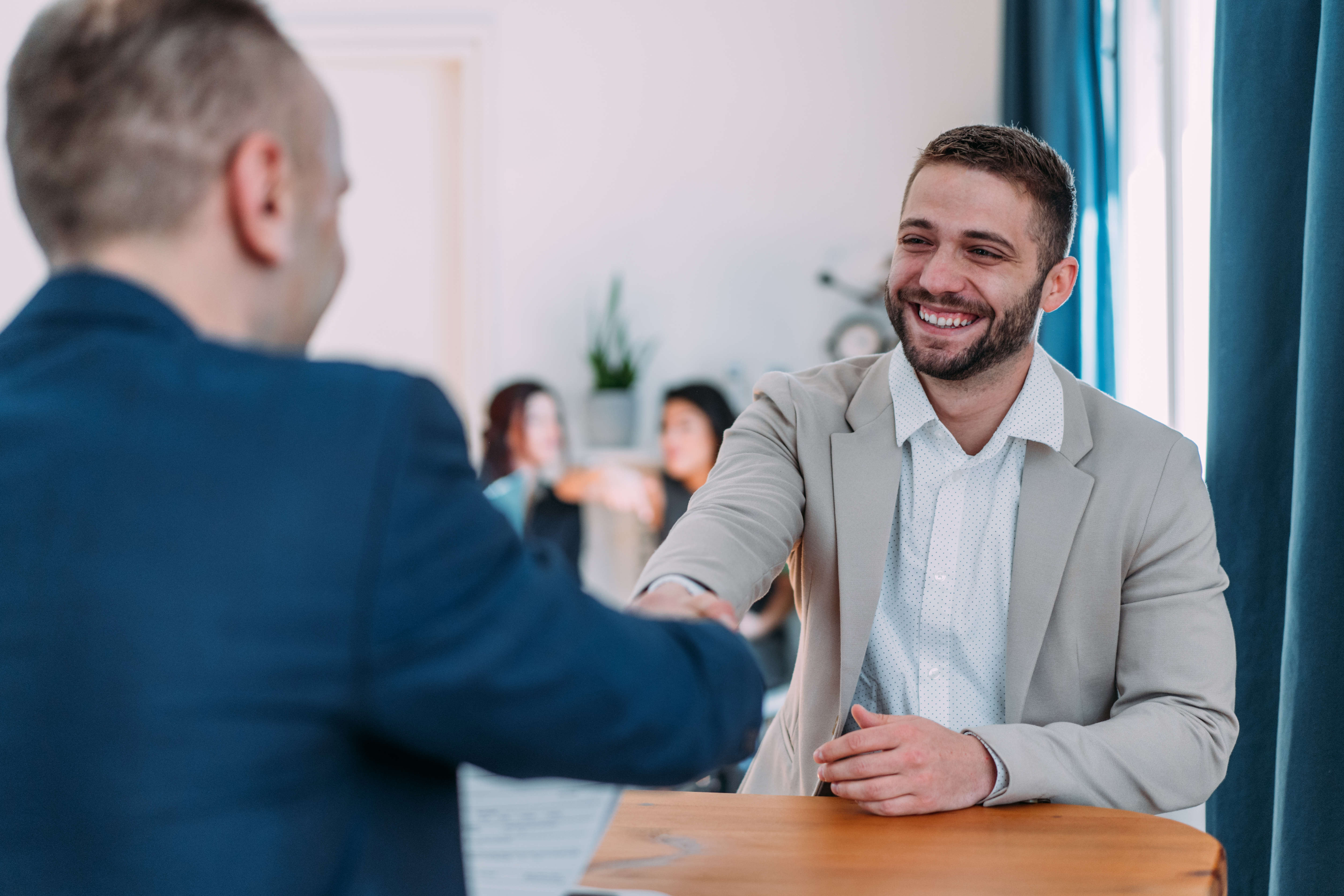 male intern shaking hands with another person