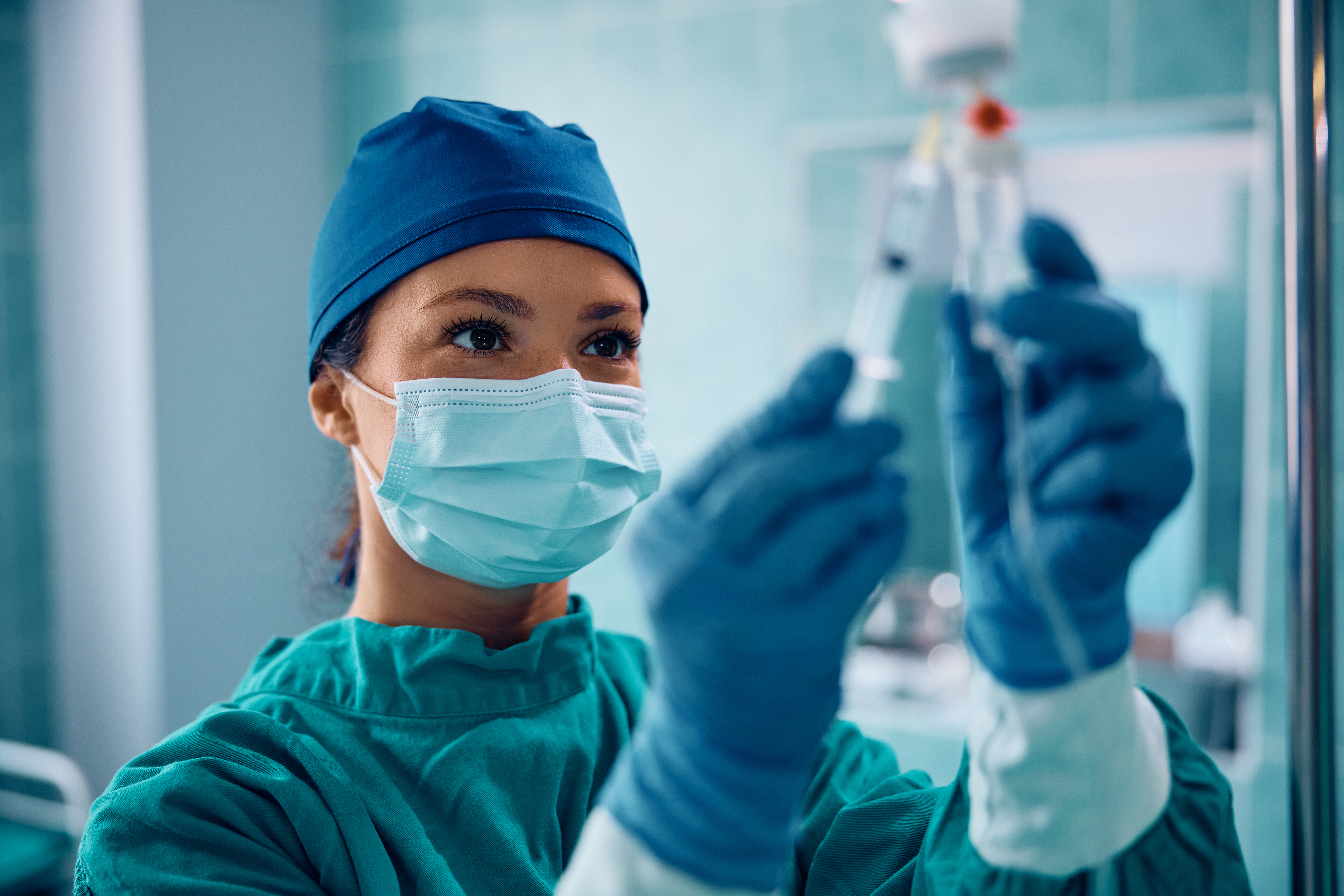 A doctor prepping an IV bag