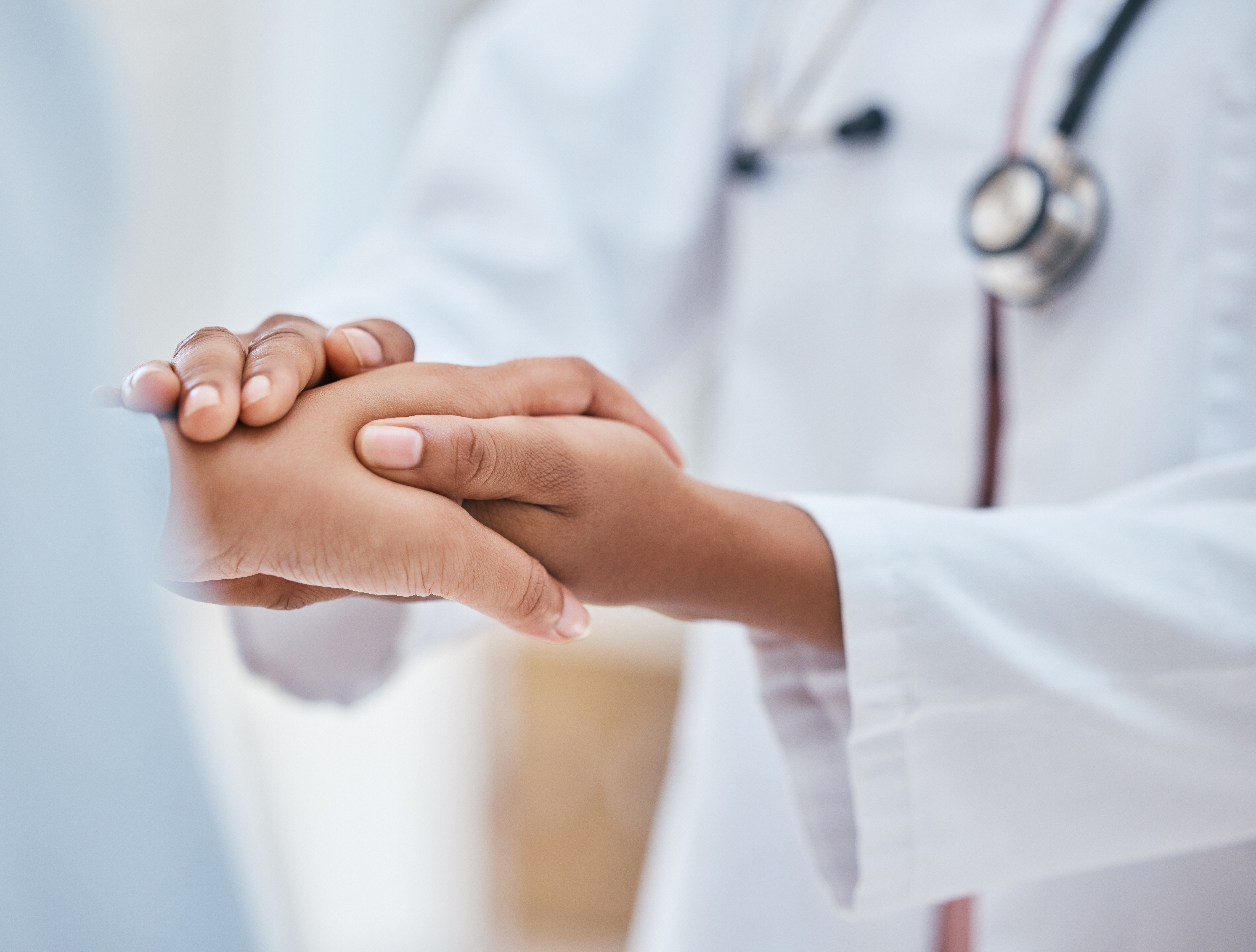 Doctor holding a patients hand