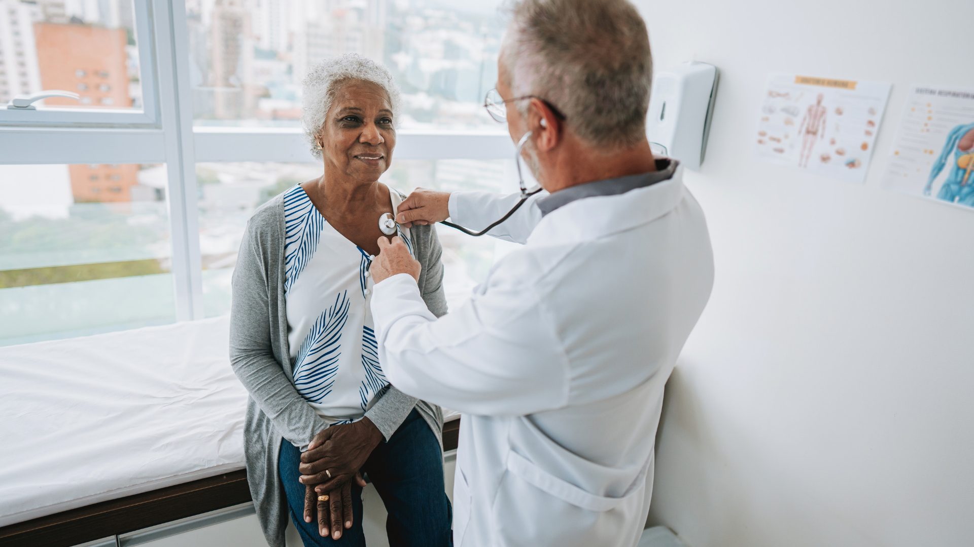 Portrait of a doctor listening to an elderly woman patient's heartbeat