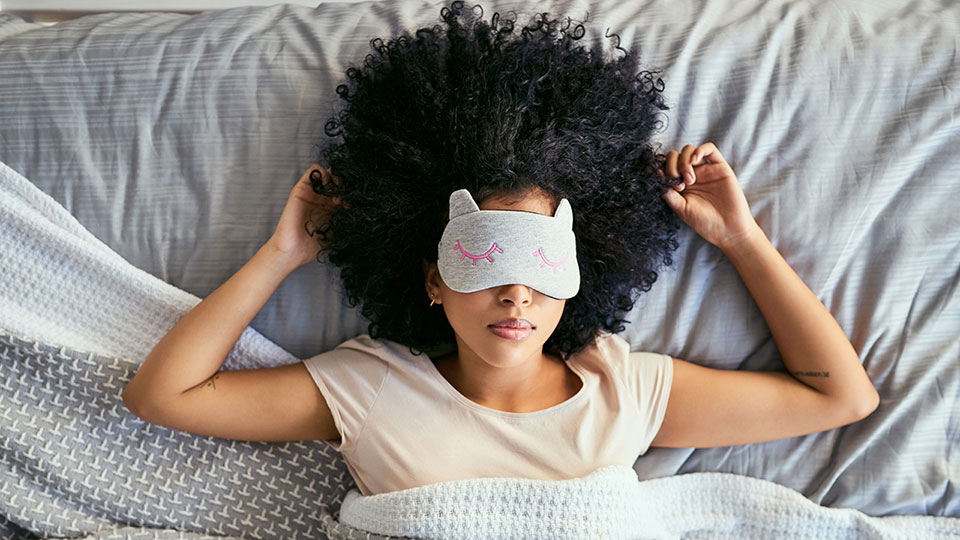Woman sleeping with fun mask