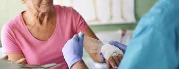 Woman receiving bandage for wound