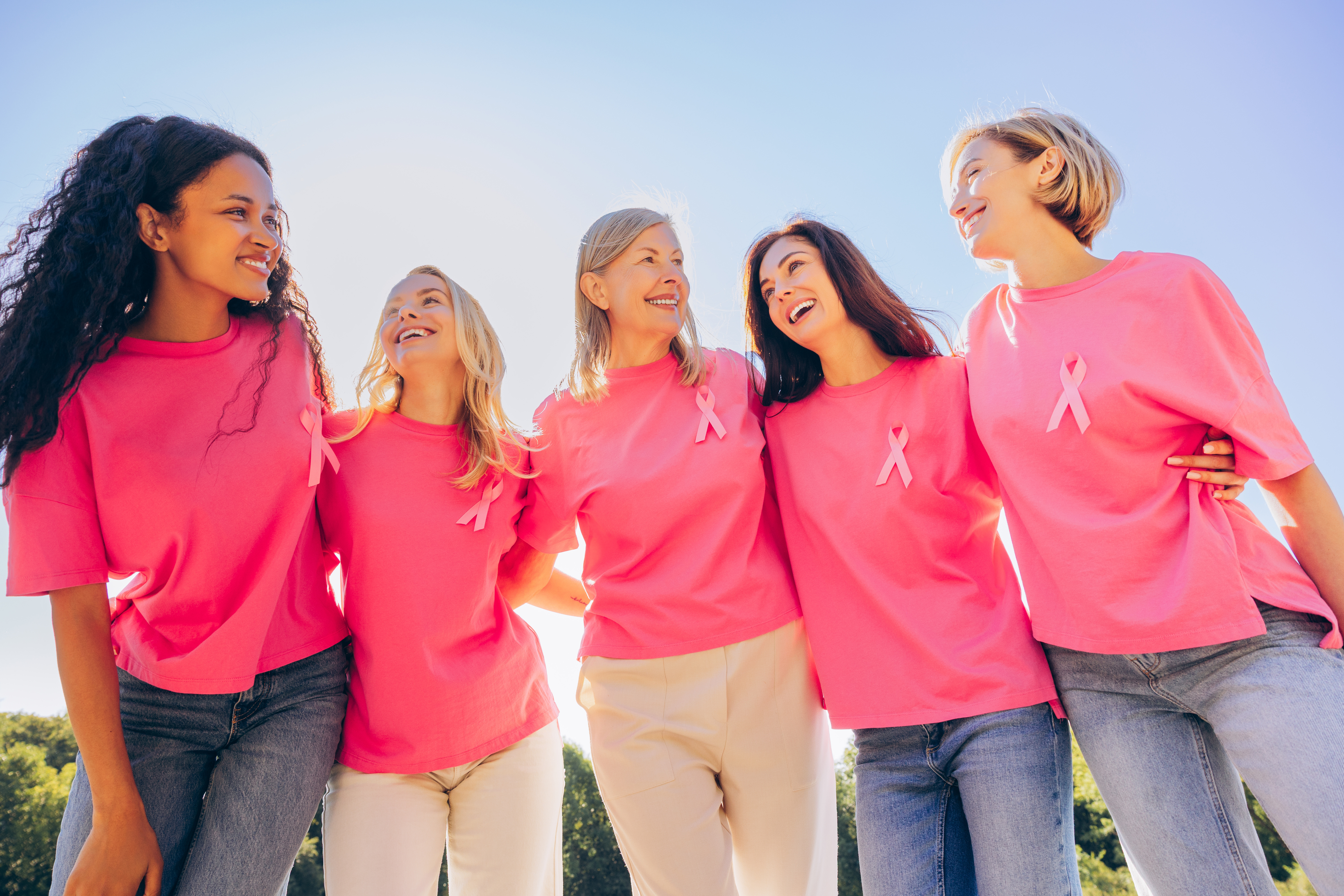 Women smiling at each other wearing pink