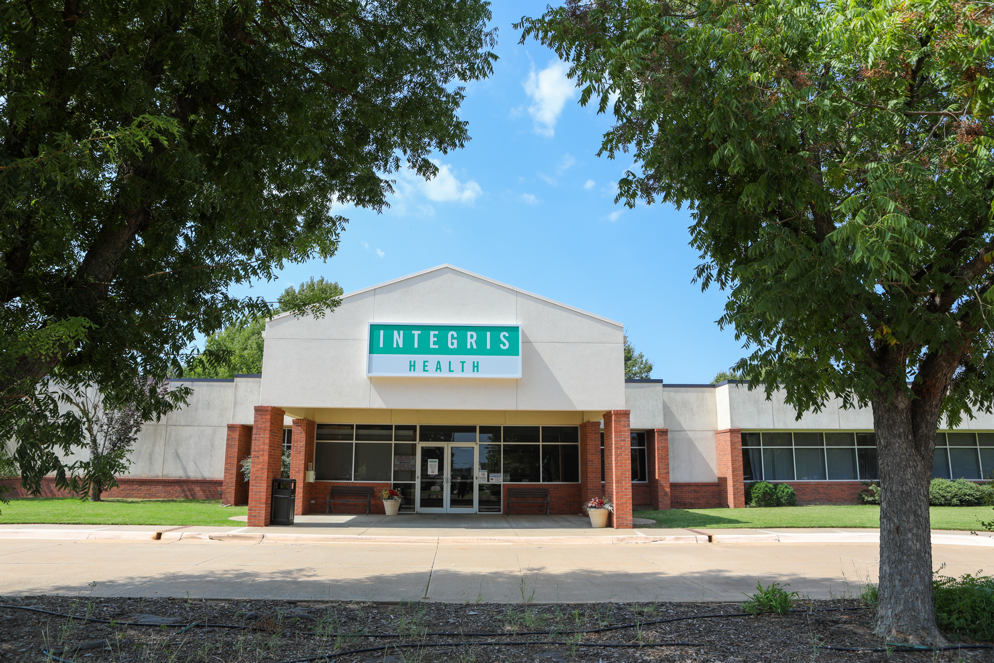 Exterior shot of building with a brick and white overhang with an INTEGRIS Health sign on the front