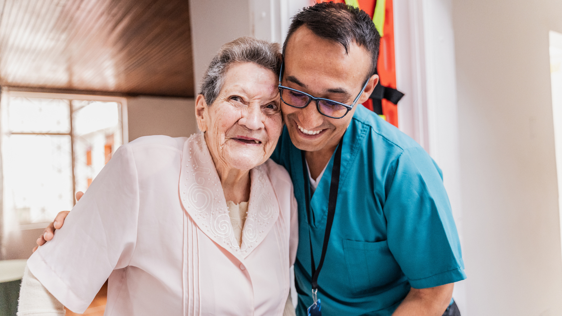 Portrait of a senior woman embracing caregiver at home