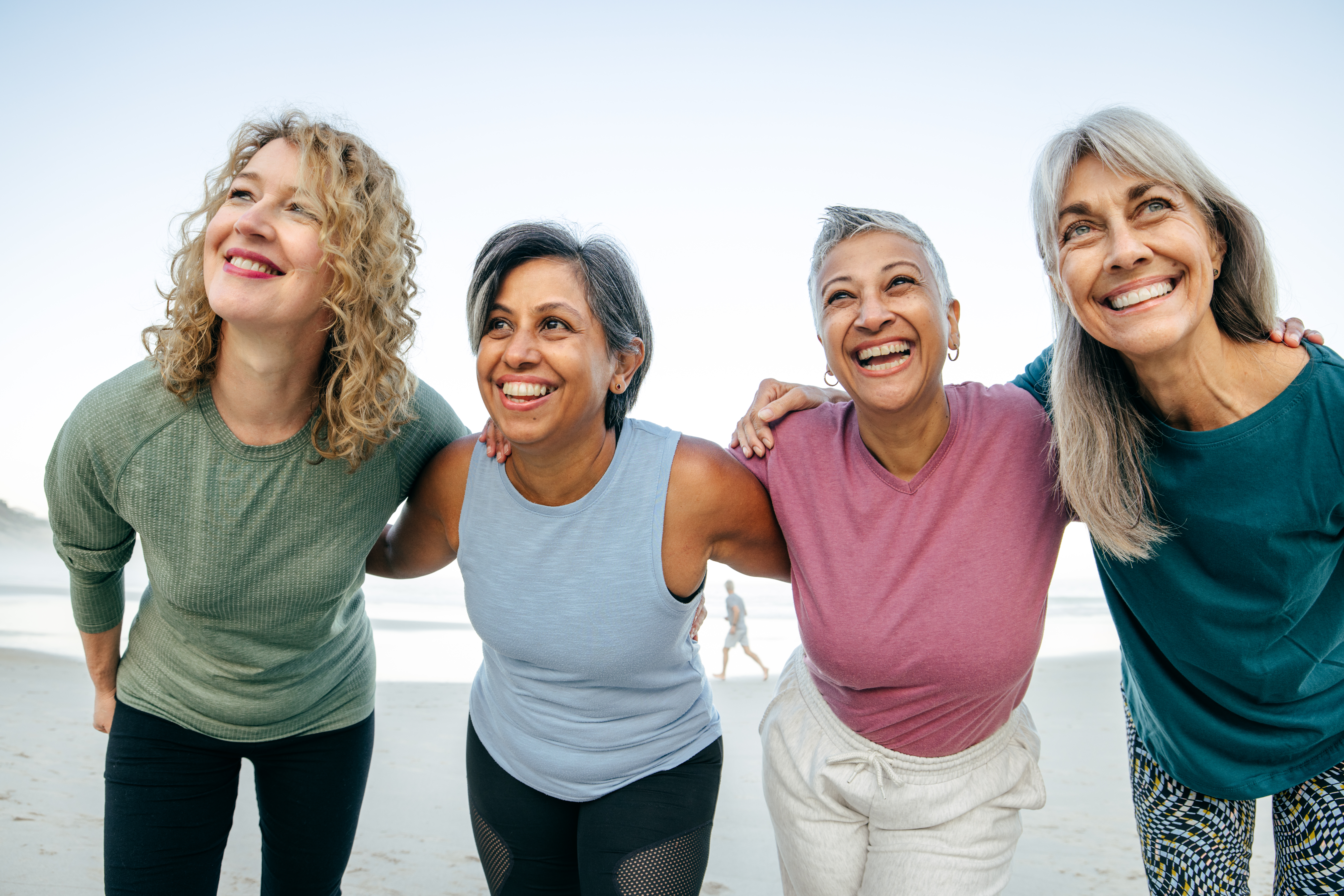 Women hugging each other smiling