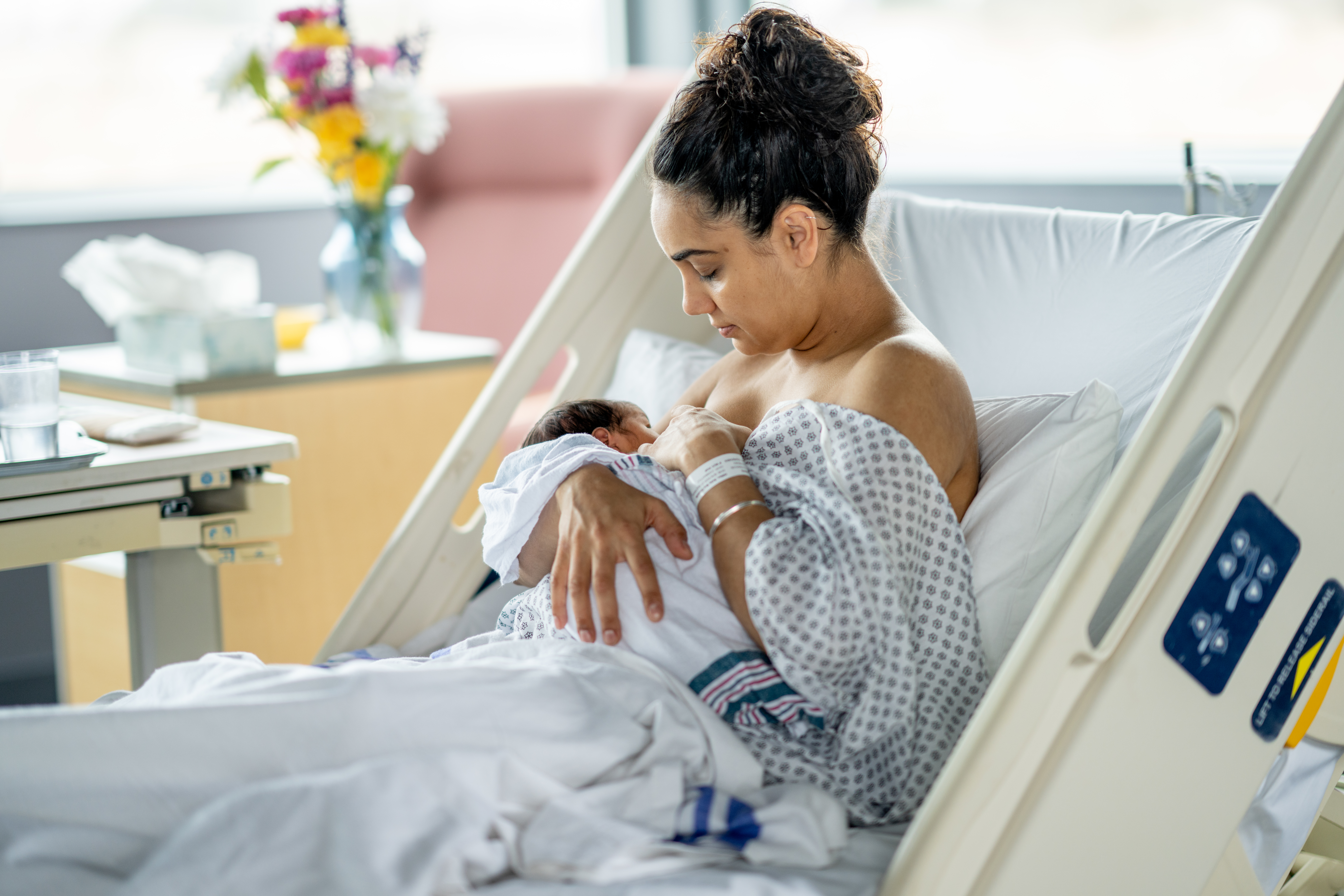 Woman breastfeeding her newborn in a hospital
