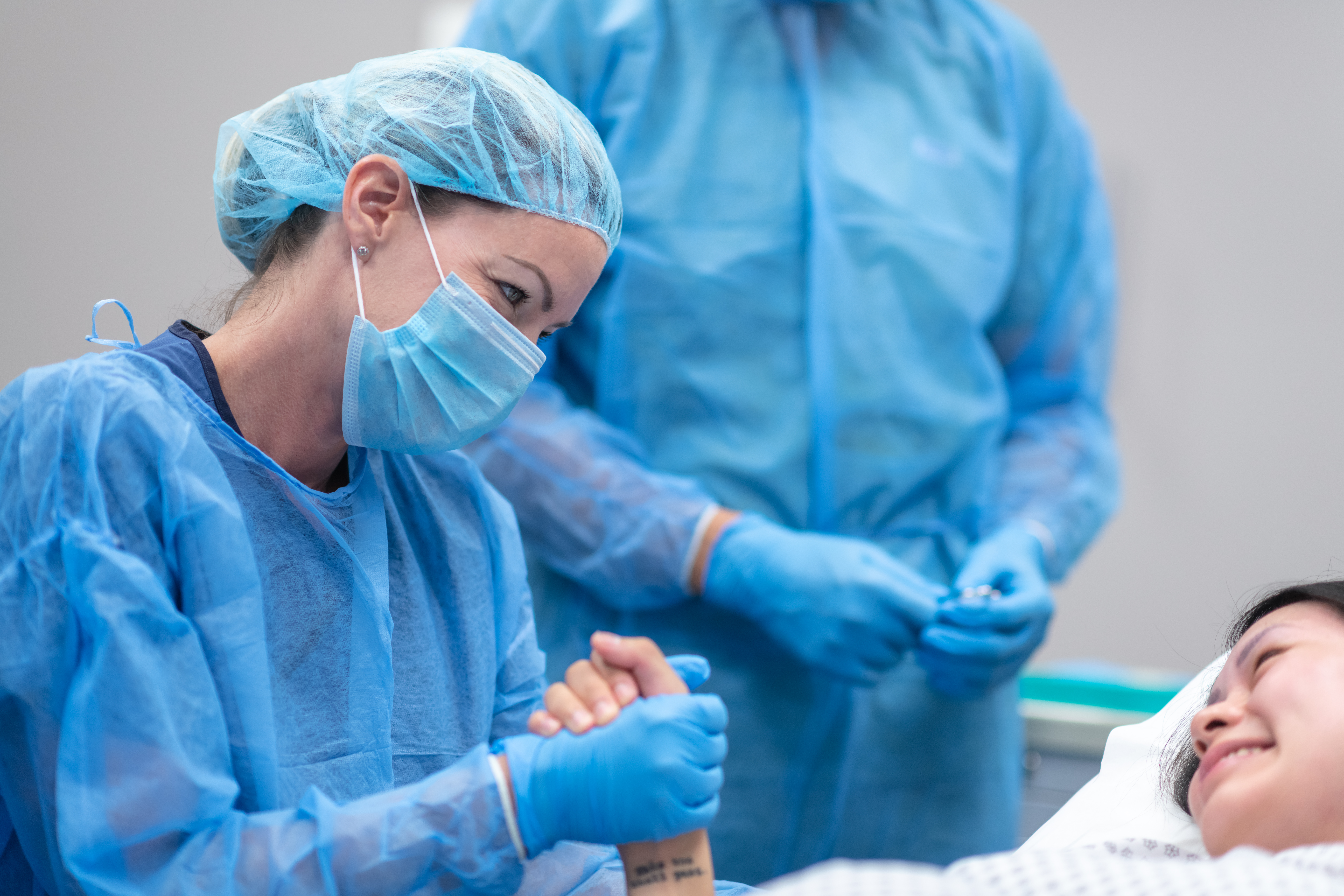 Surgeon holding patients hand before surgery