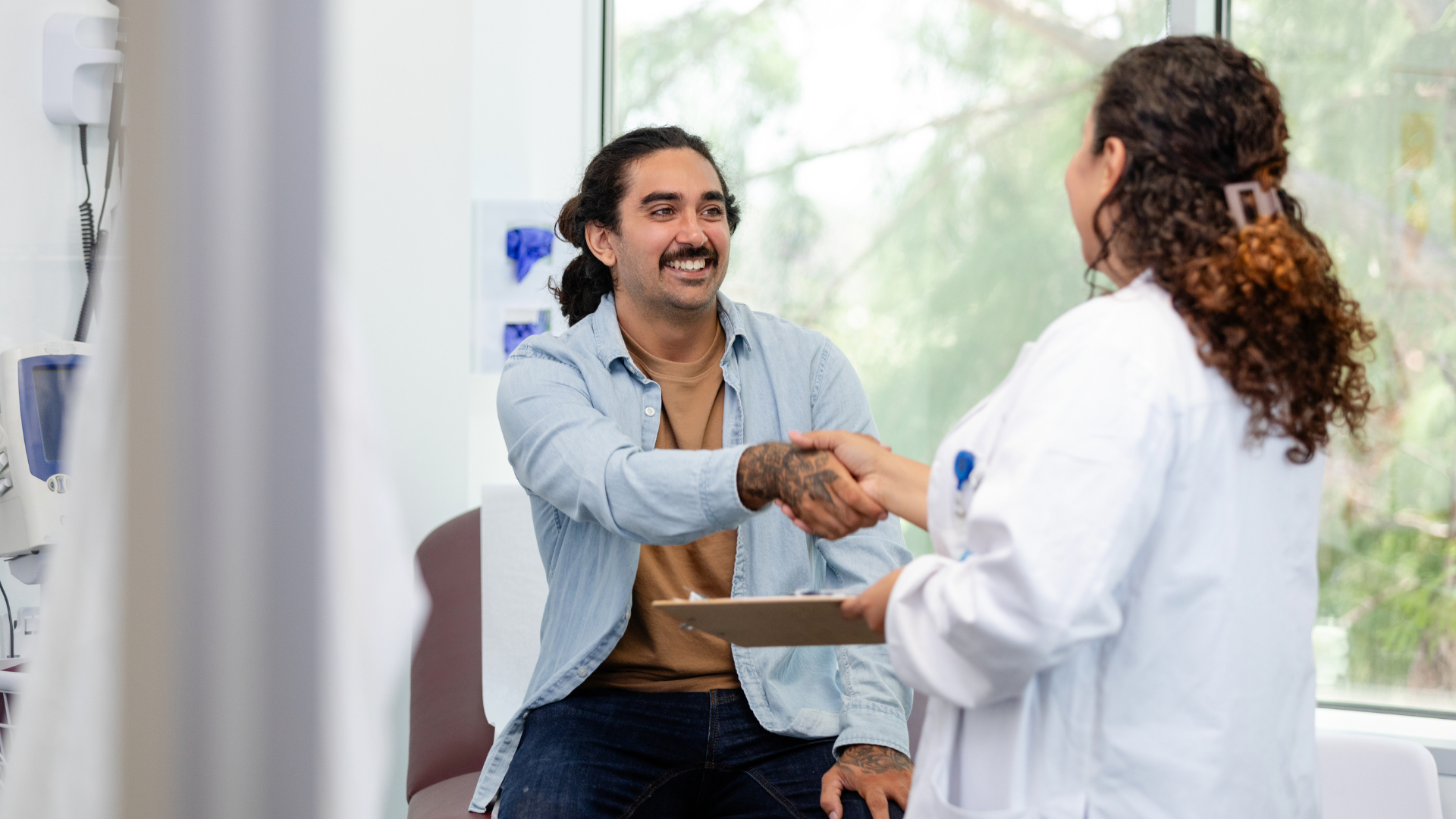 Doctor and Patient Shaking Hands in Medical Office