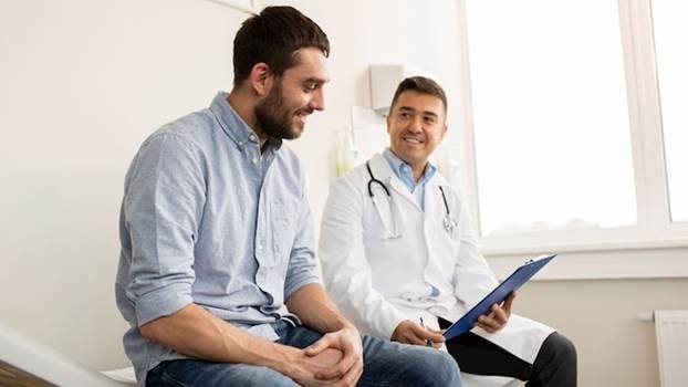 Man sitting with doctor