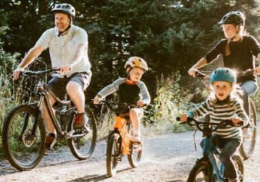 Photo of family riding bikes
