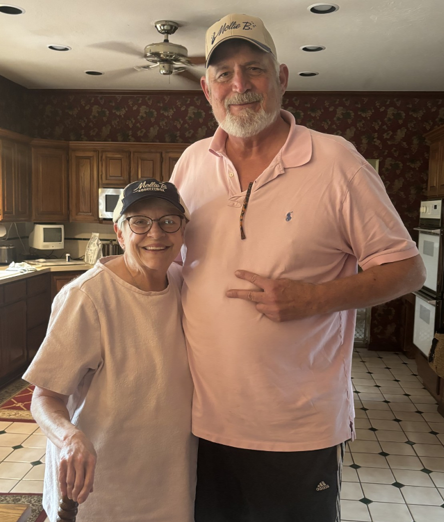 Kathy Allen smiling and hugging her husband Doug Allen