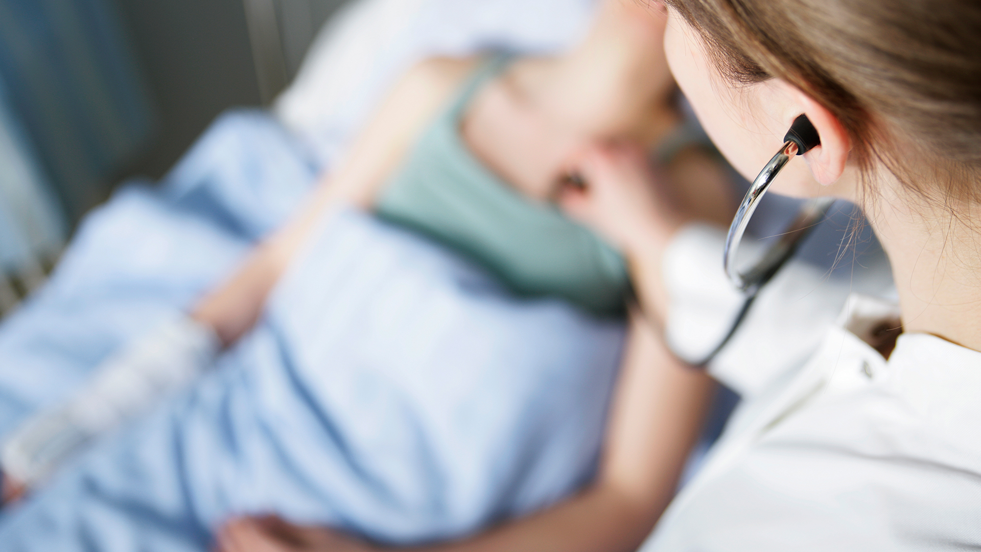 caregiver checking patient's heartbeat