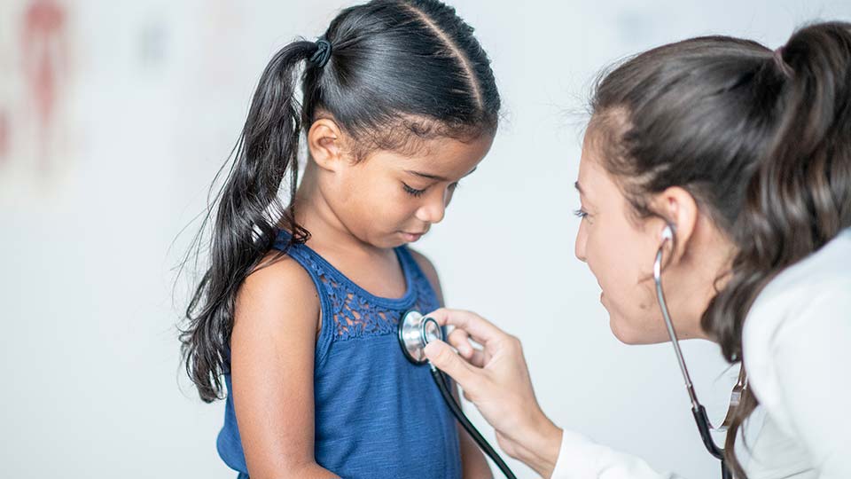 Doctor examining a young patient