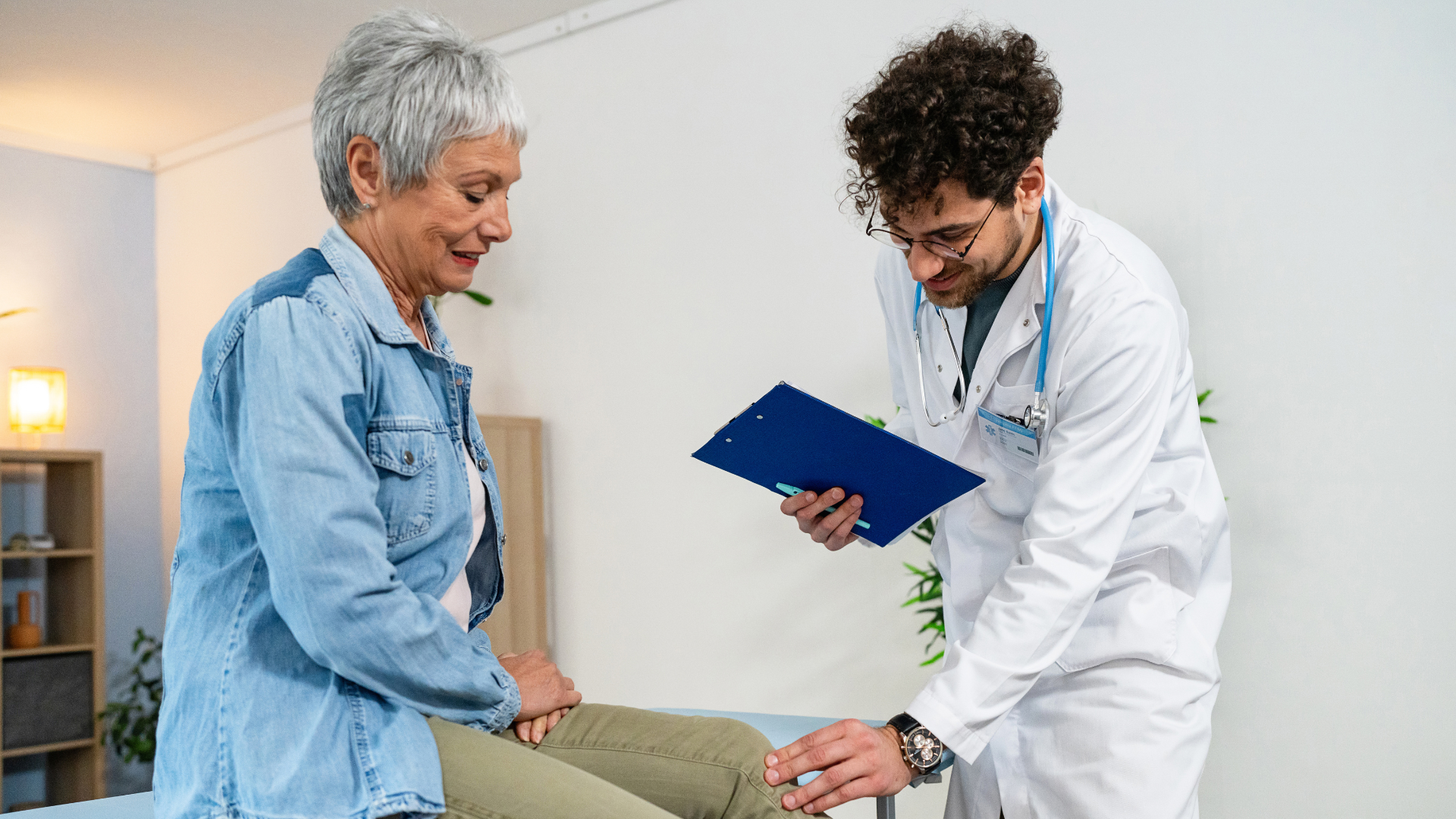 Doctor examining patients knee