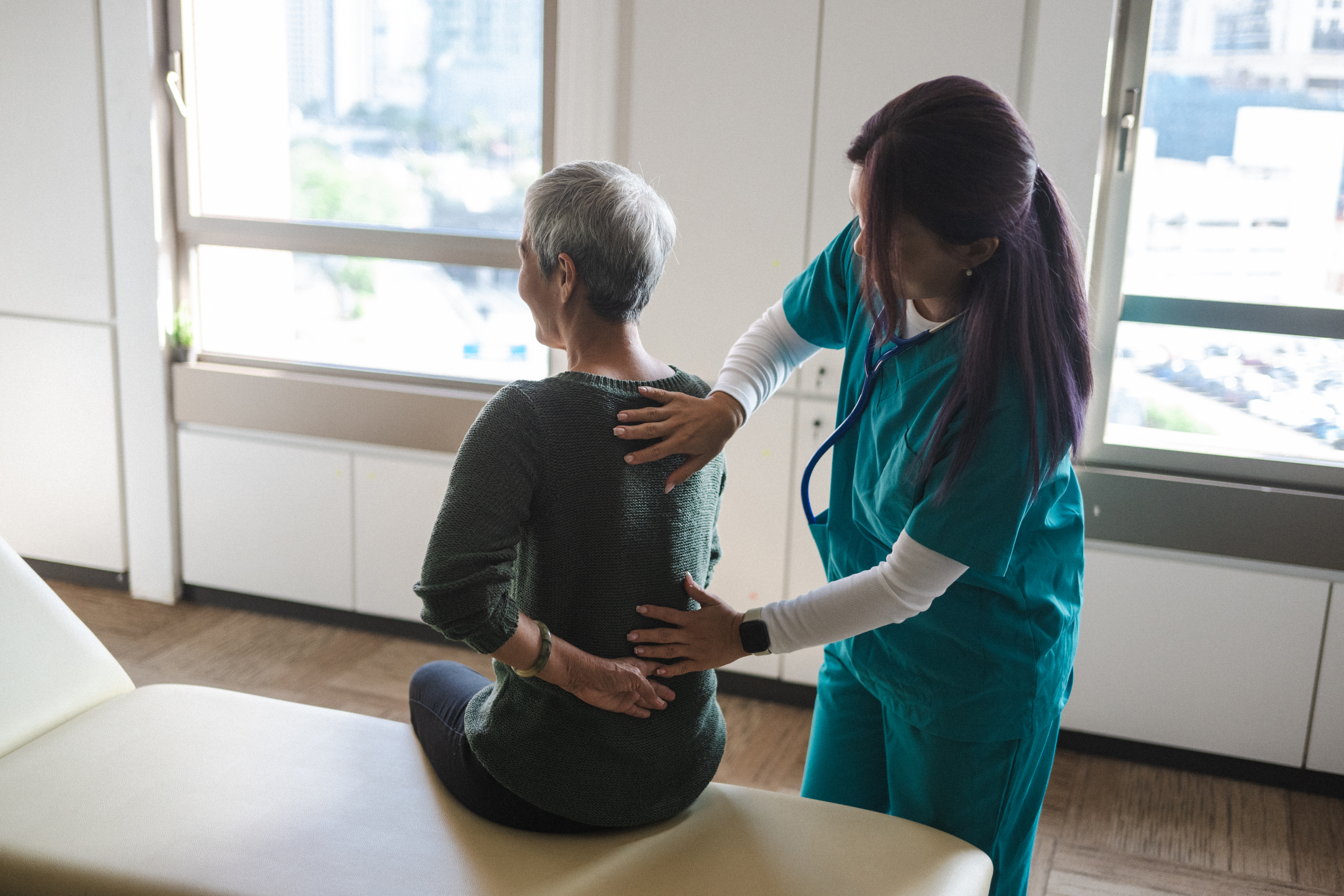 Physiotherapist Aids Senior in Recovery