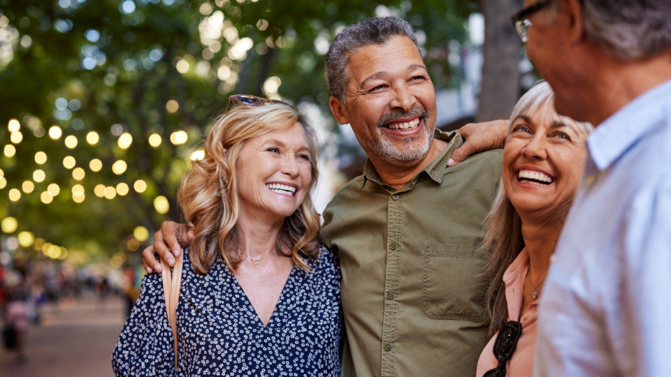Mature women and men laughing together