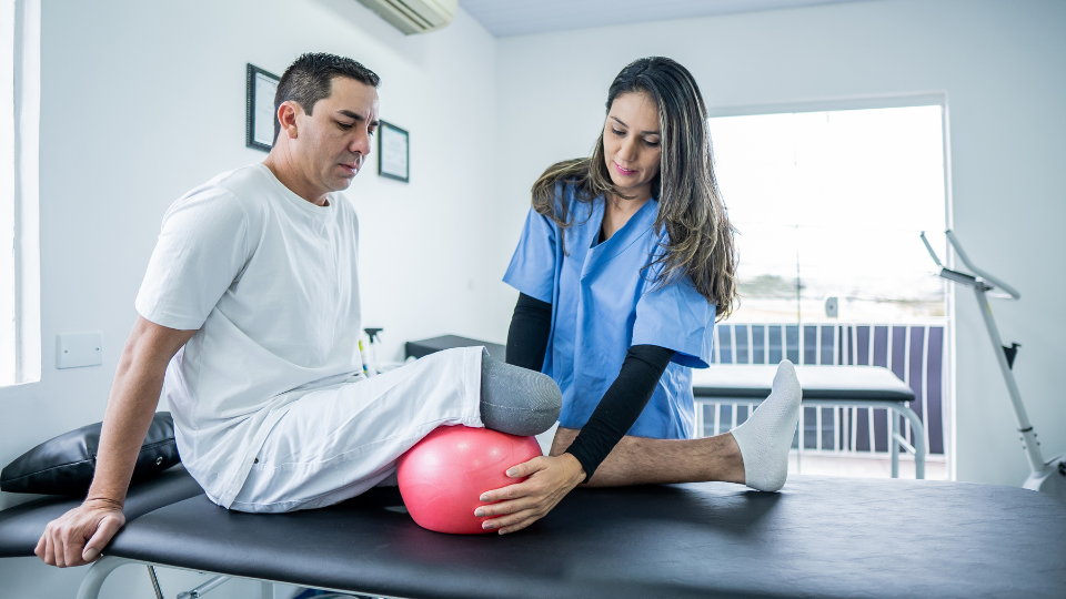 A patient with an amputated leg doing physical therapy with a specialist