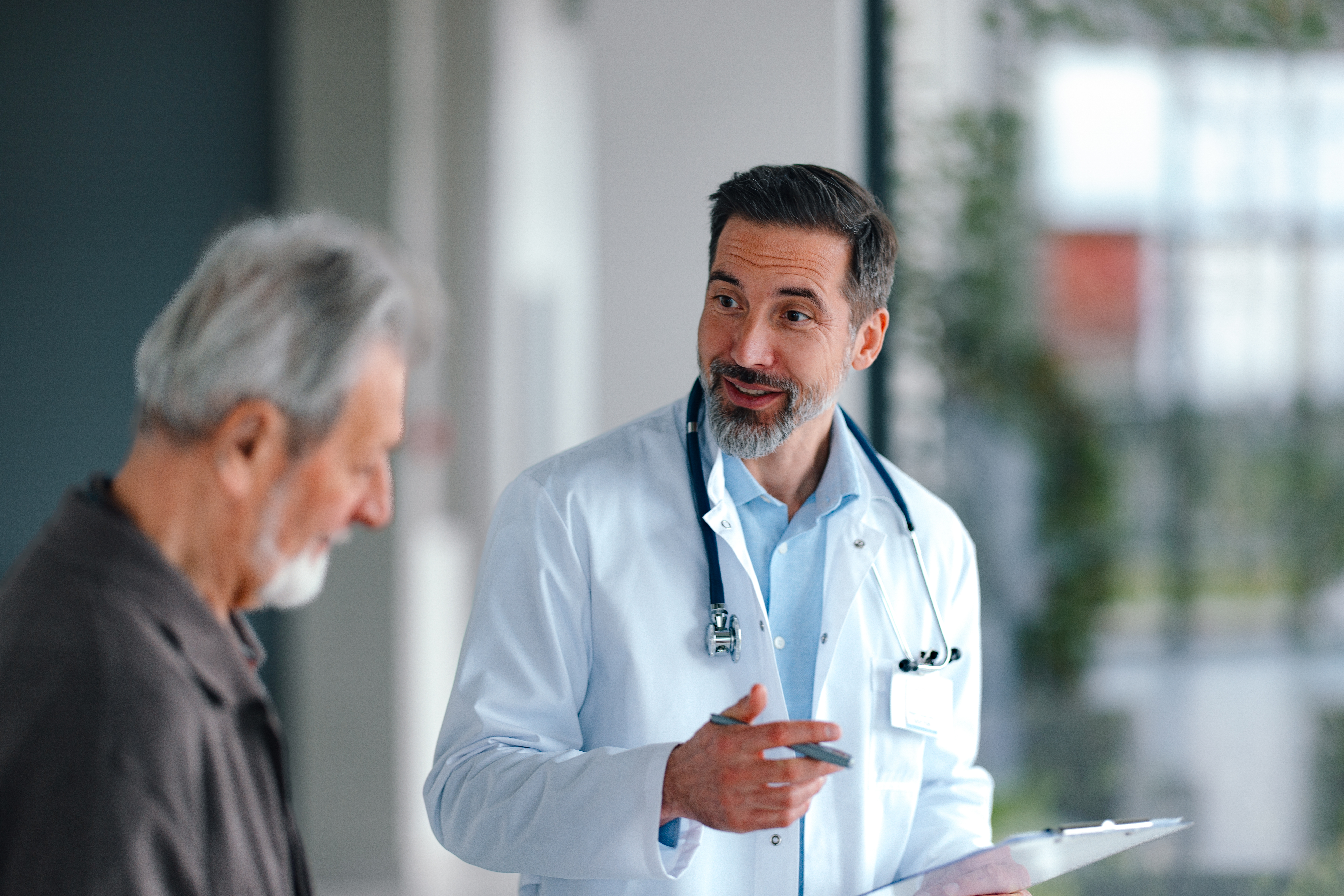 Doctor smiling and talking to an elderly patient