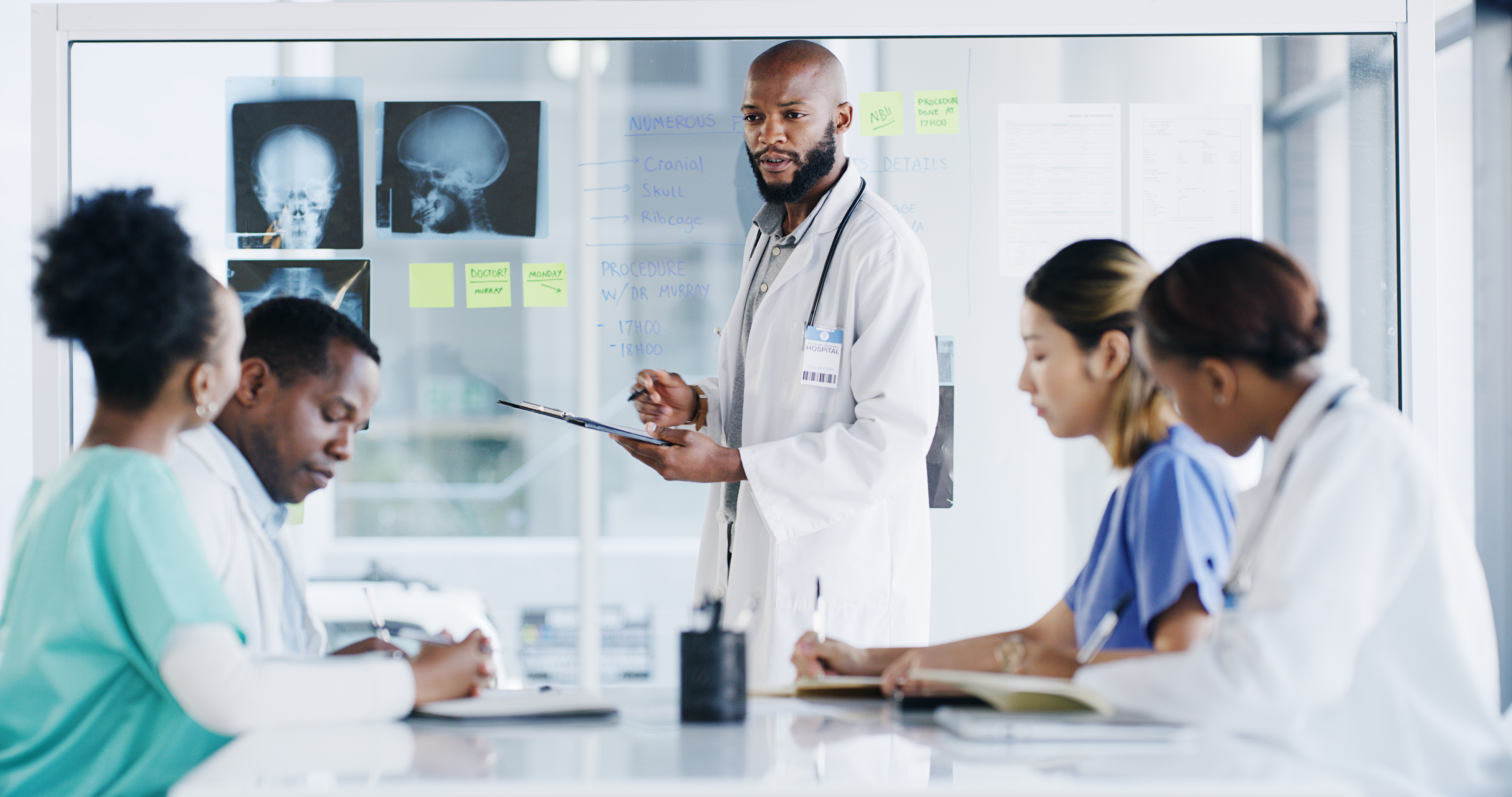 Doctors sitting in a board room discussing a treatment plan