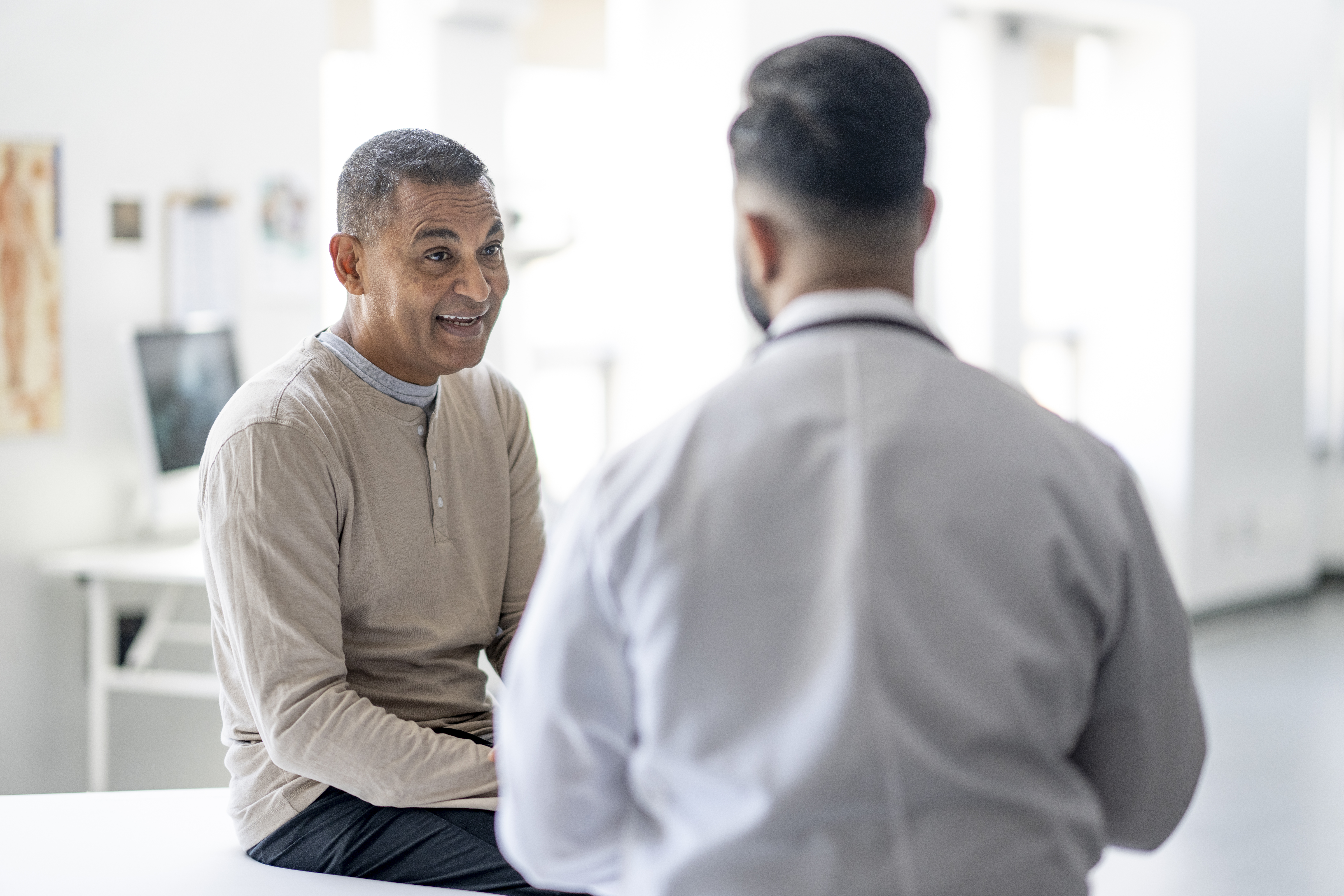 Patient smiling and talking to a doctor