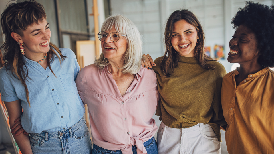 Group of women smiling and hugging each other
