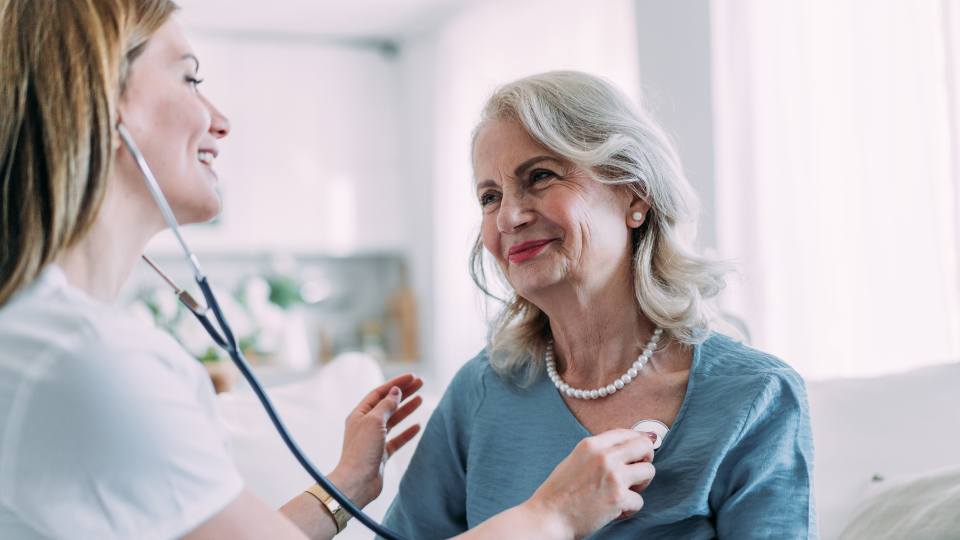 Older lady getting her heart checked by a nurse