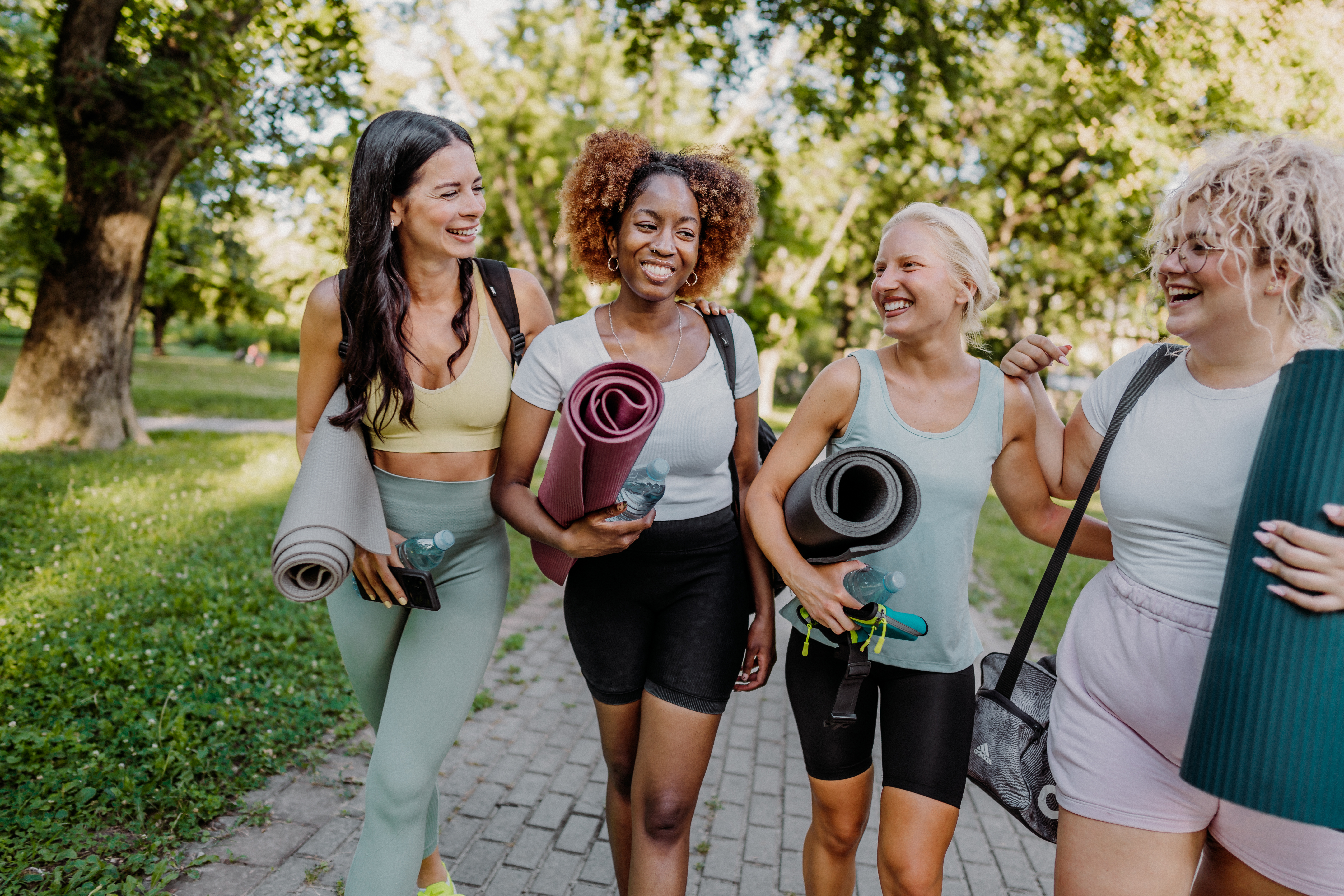 Women in the park leaving their yoga class.