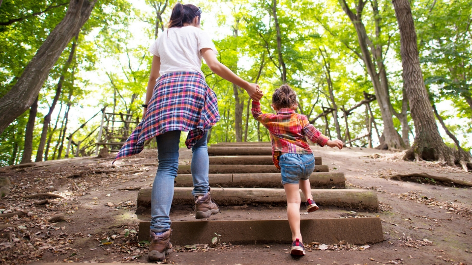 Mother and young daughter hiking
