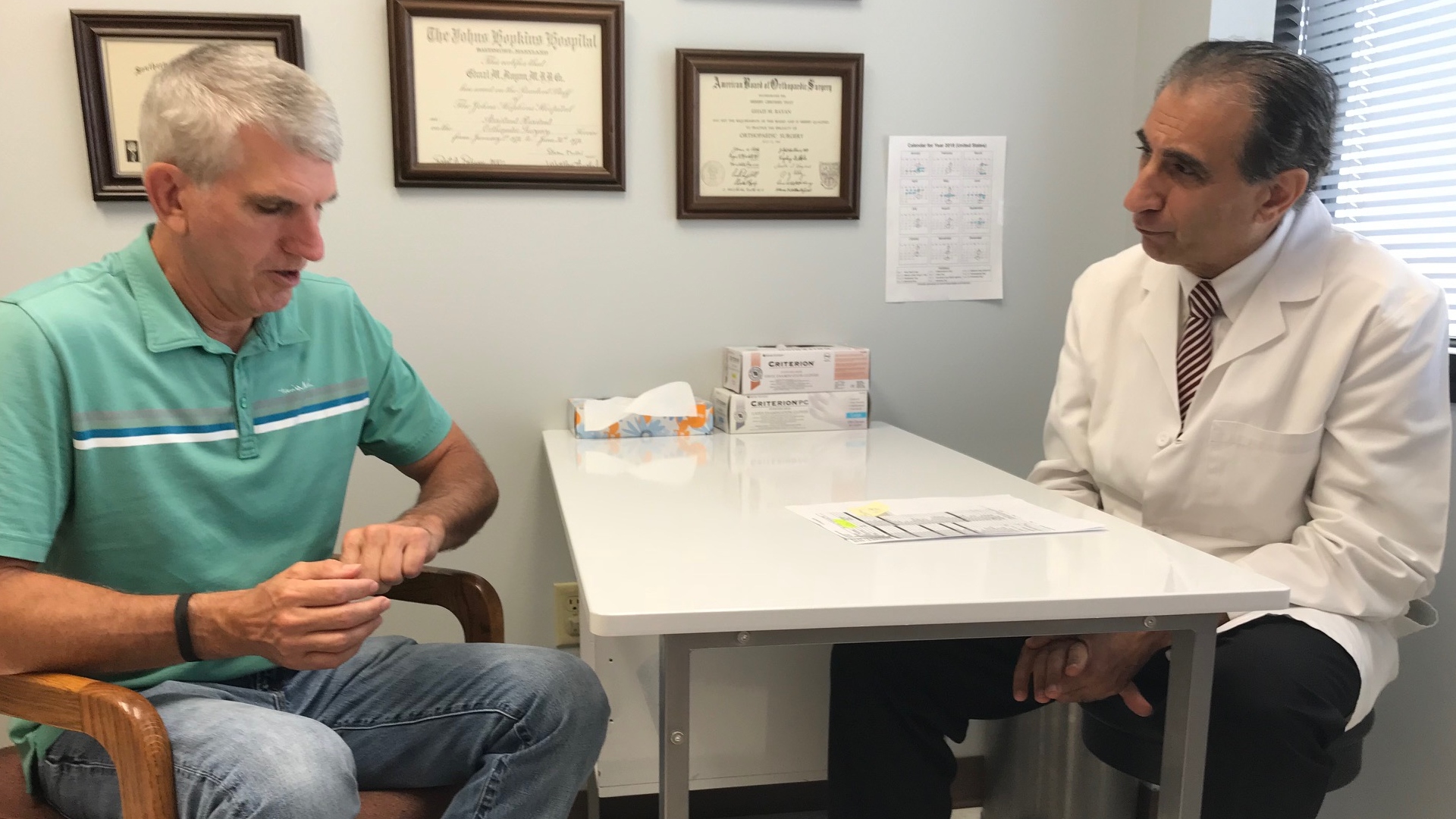 Hand surgeon consulting with a patient