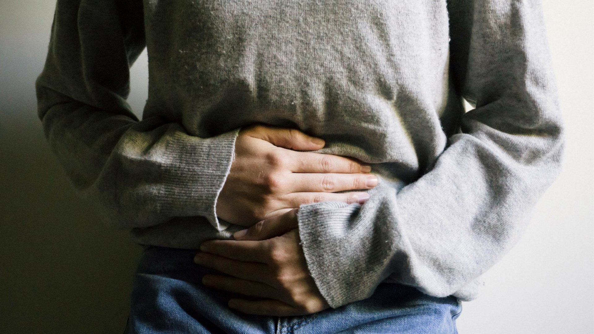 woman clutching her stomach