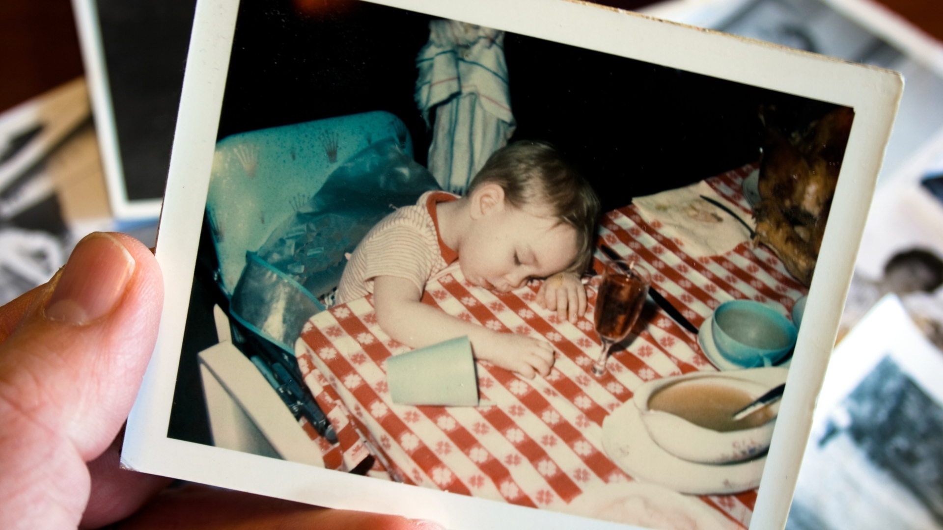 snapshot of a little boy asleep at the Thanksgiving dinner table