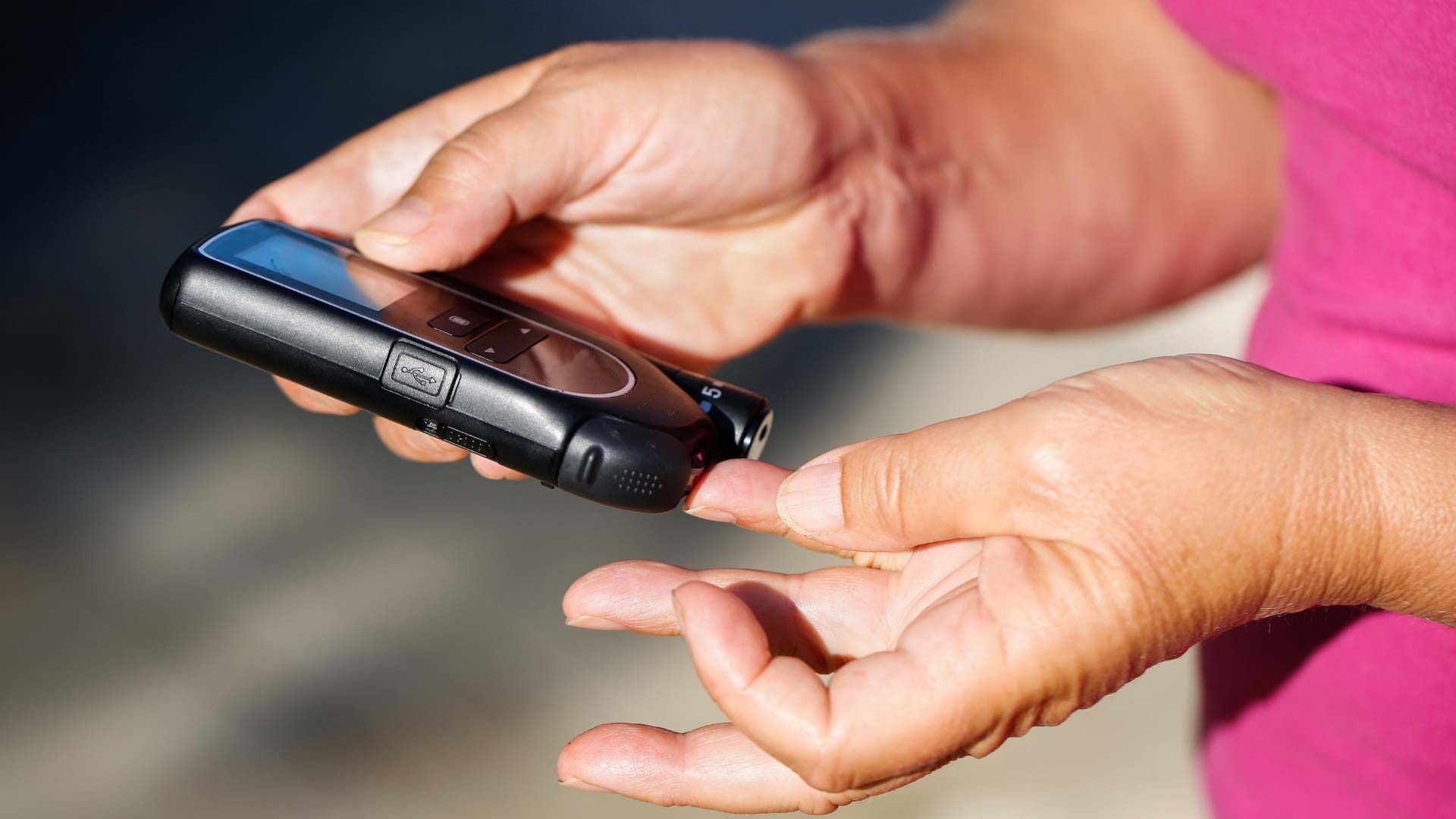 woman testing blood sugar
