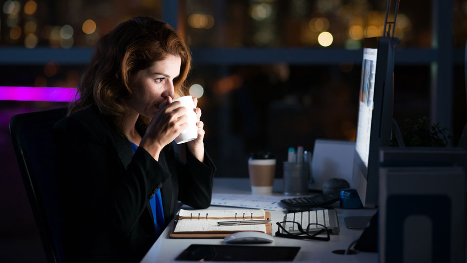 woman looking at her bright computer screen