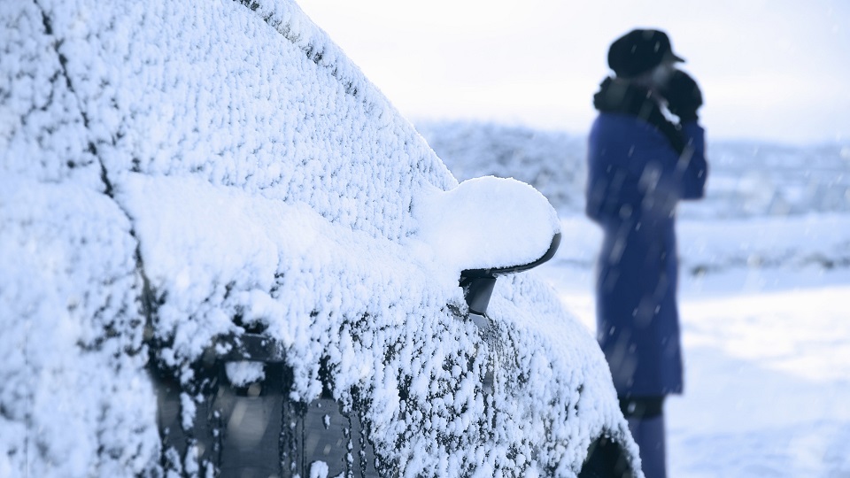 woman having car trouble in snow