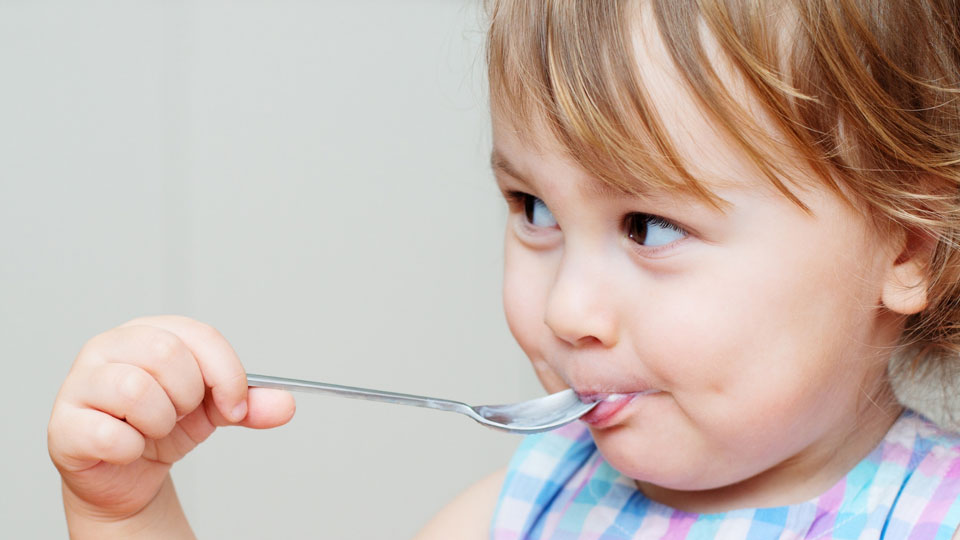 little girl eating yogurt