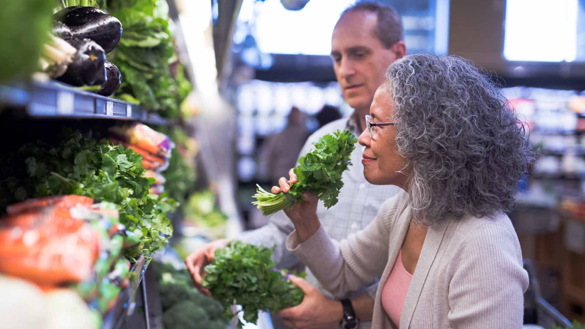 woman looking at vegetables in store