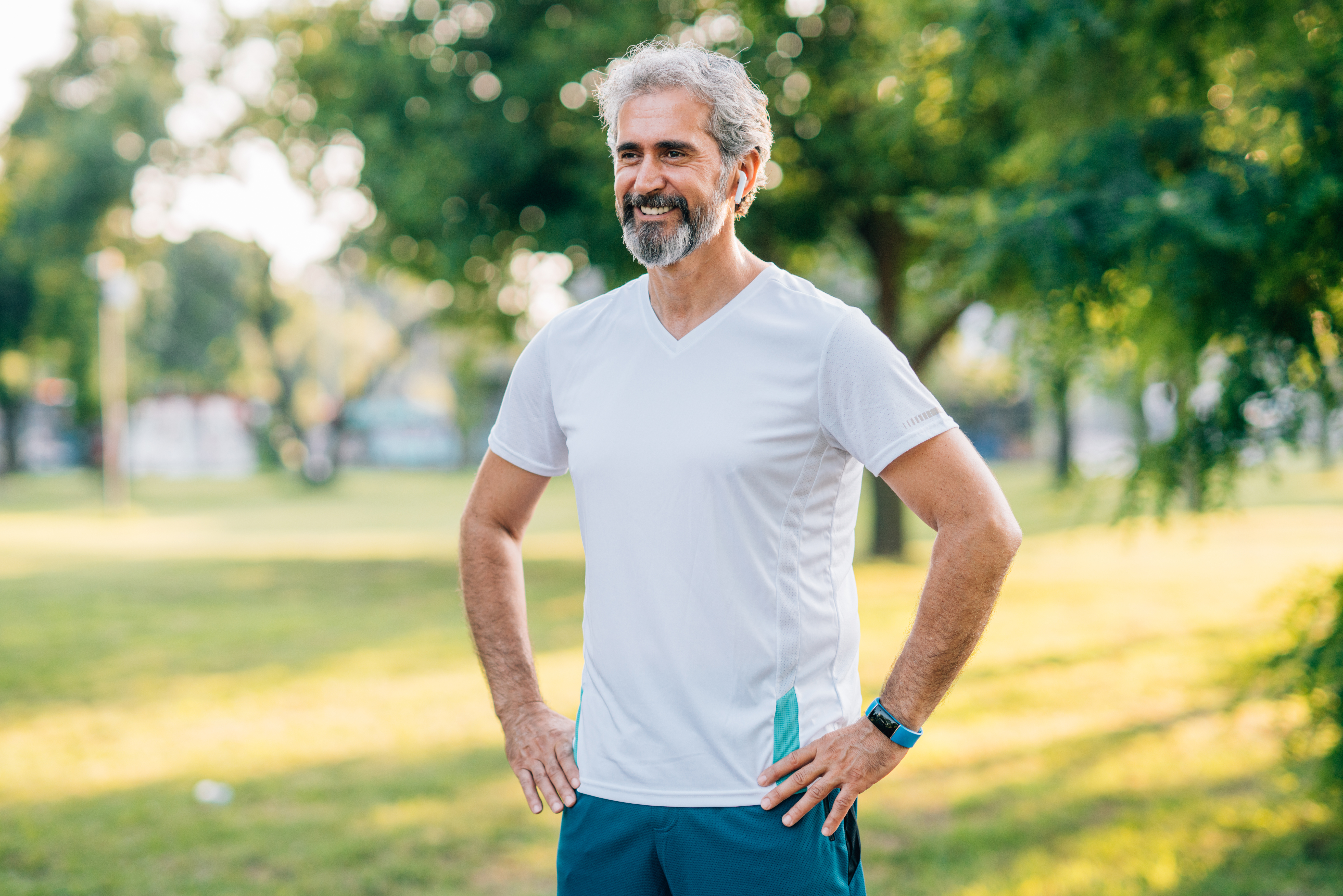 An older man with headphones in about to exercise
