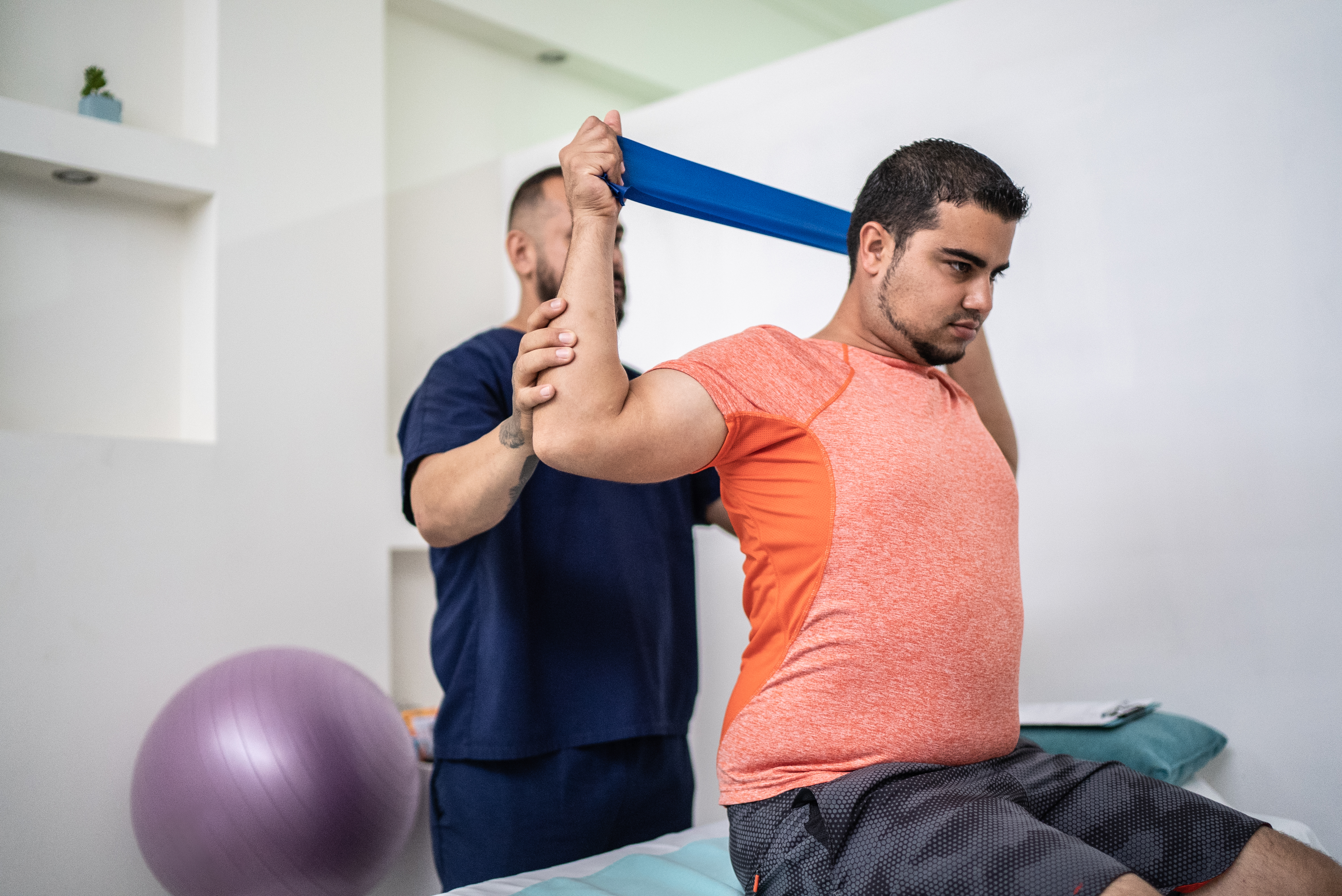 A man exercises with a resistance band