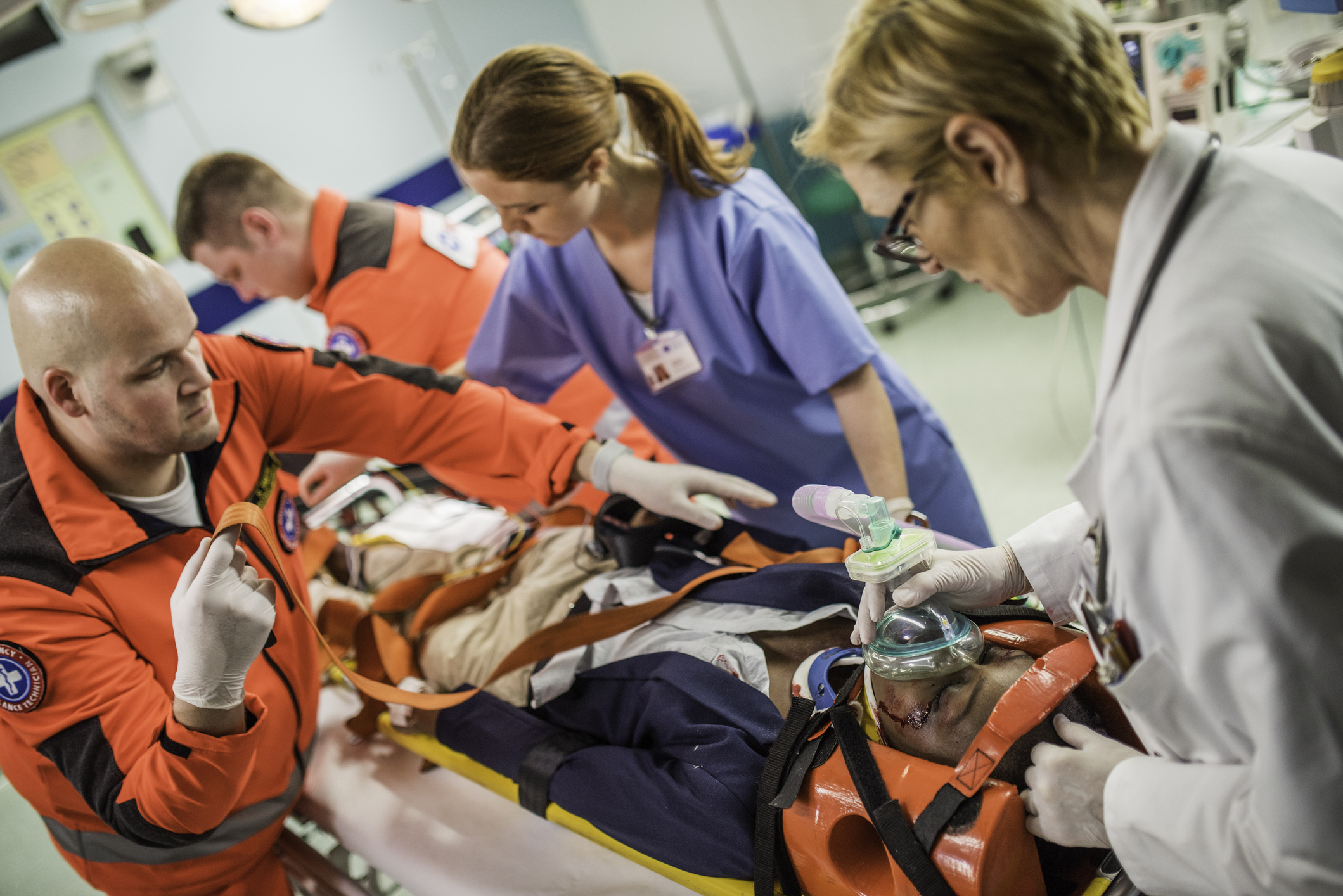 A patient in a stretcher receives trauma care