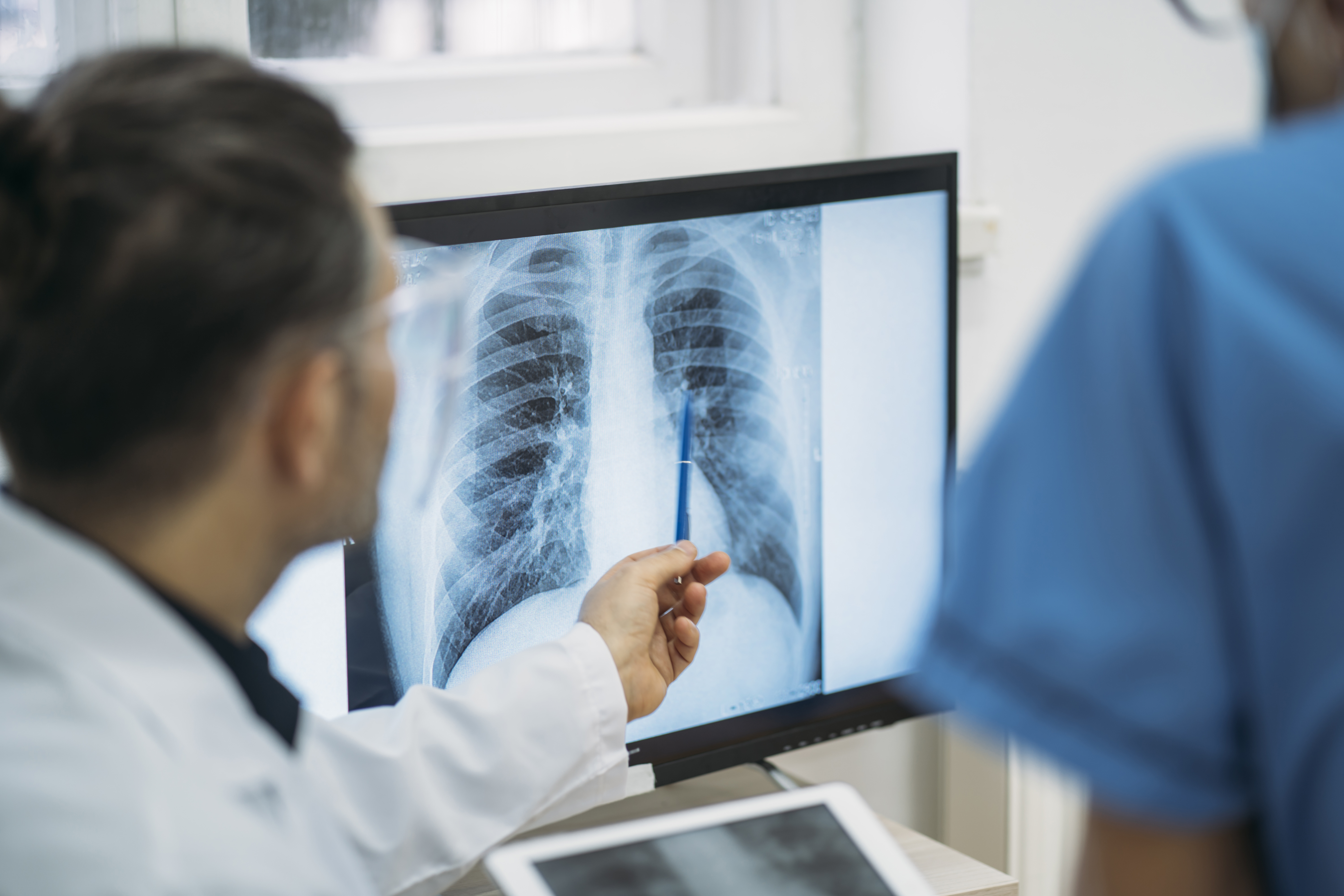 a health care provider points to a chest x ray