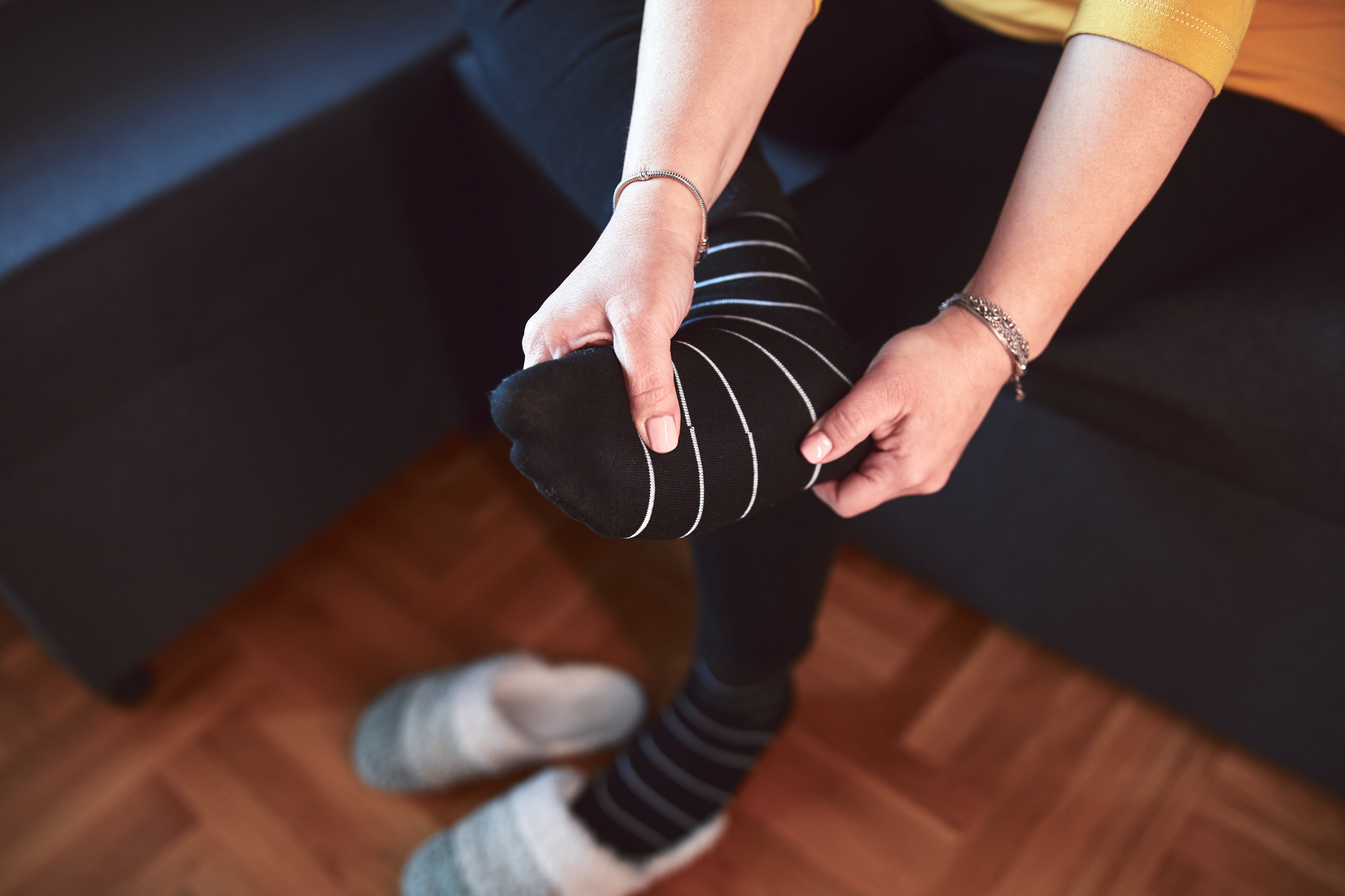 Woman with ankle and foot pain at home.