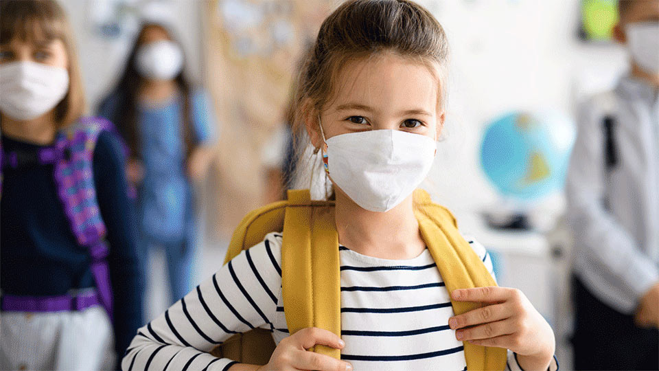 young girl wearing a mask to combat COVID-19