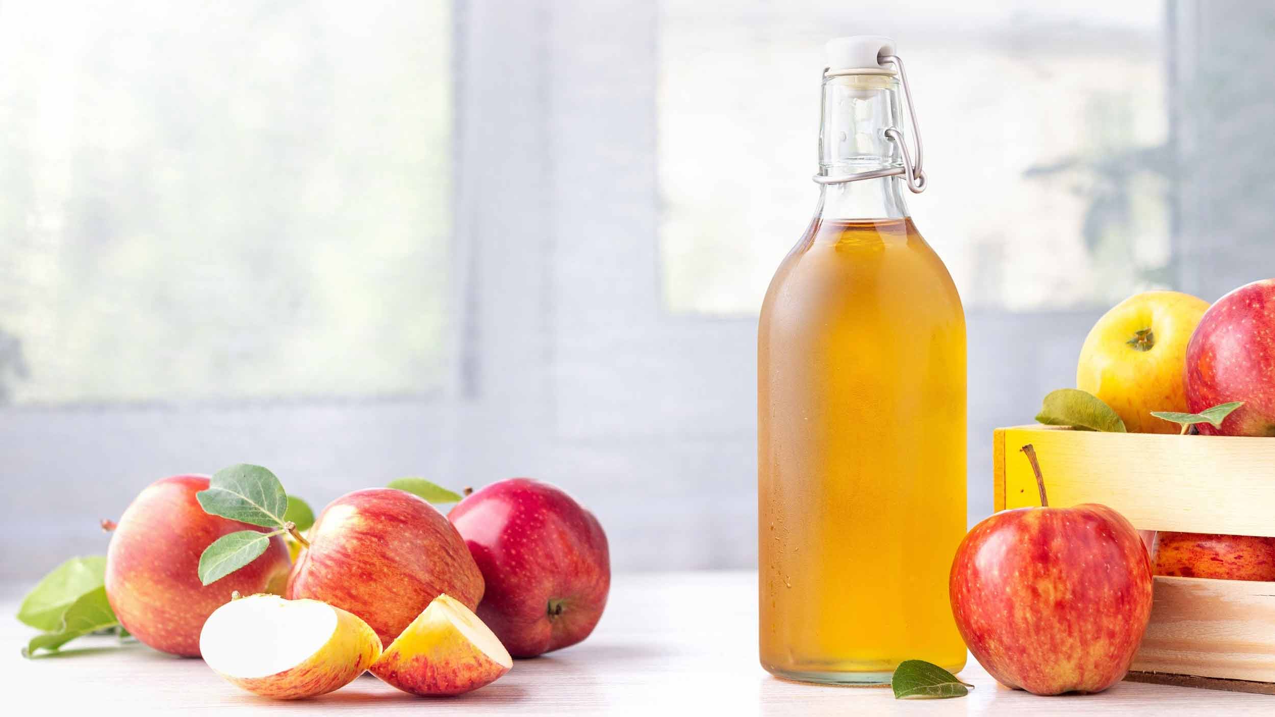 apples and a bottle of apple cider vinegar
