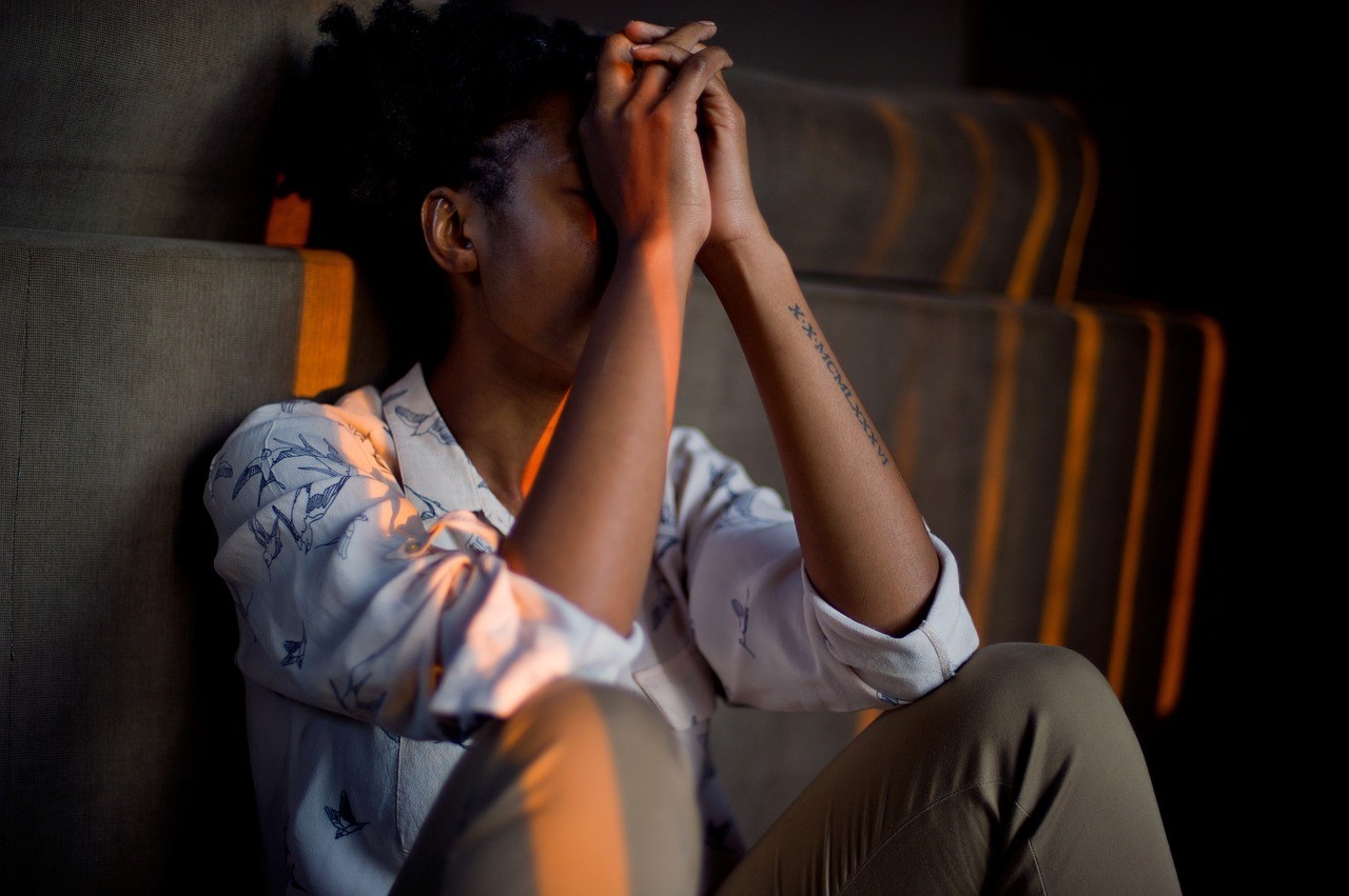 Distressed Woman with Face in Hands