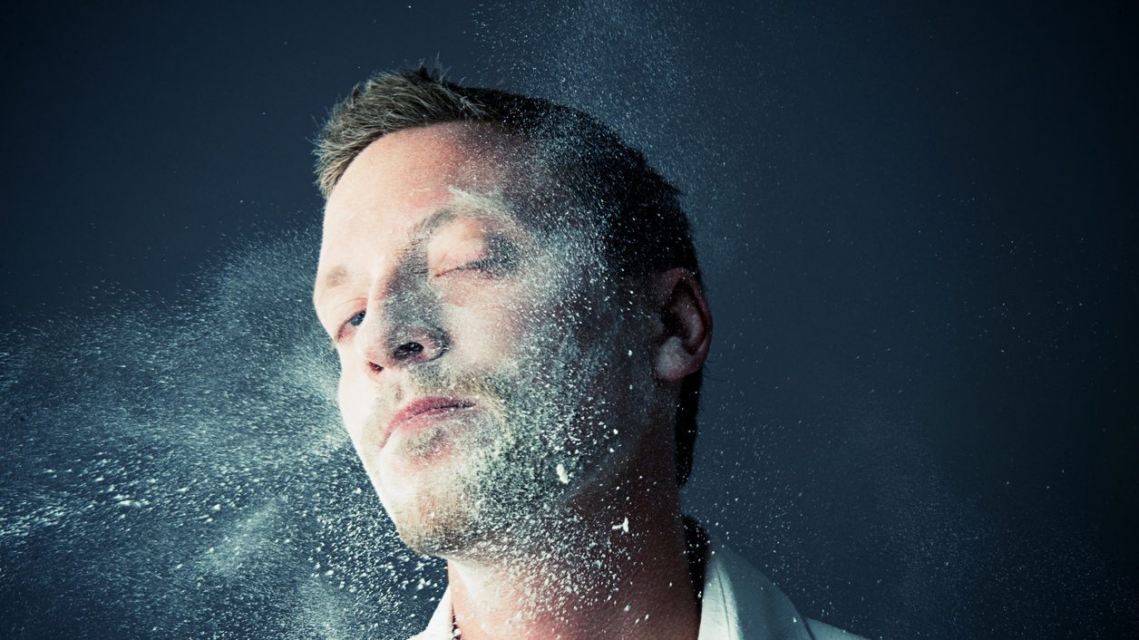 man getting hit with flour in face