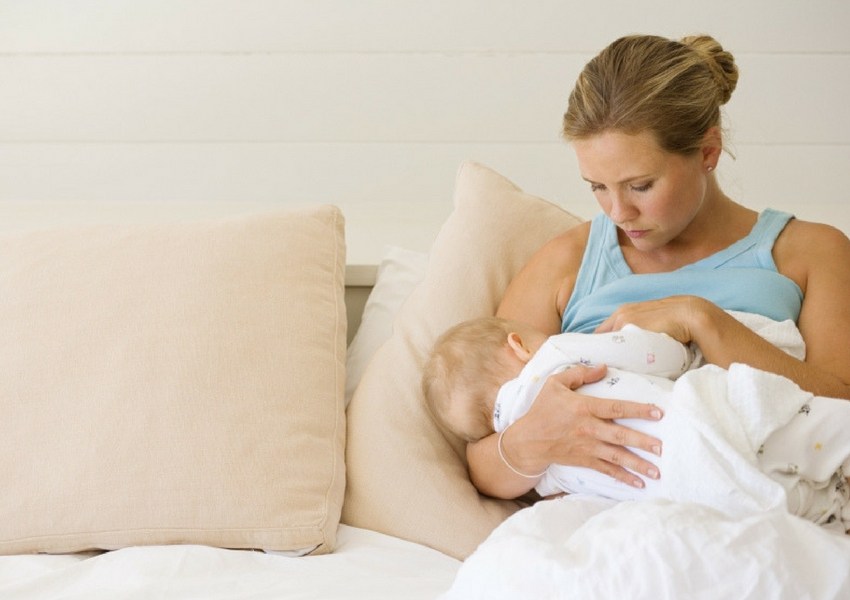 mother breastfeeding small infant