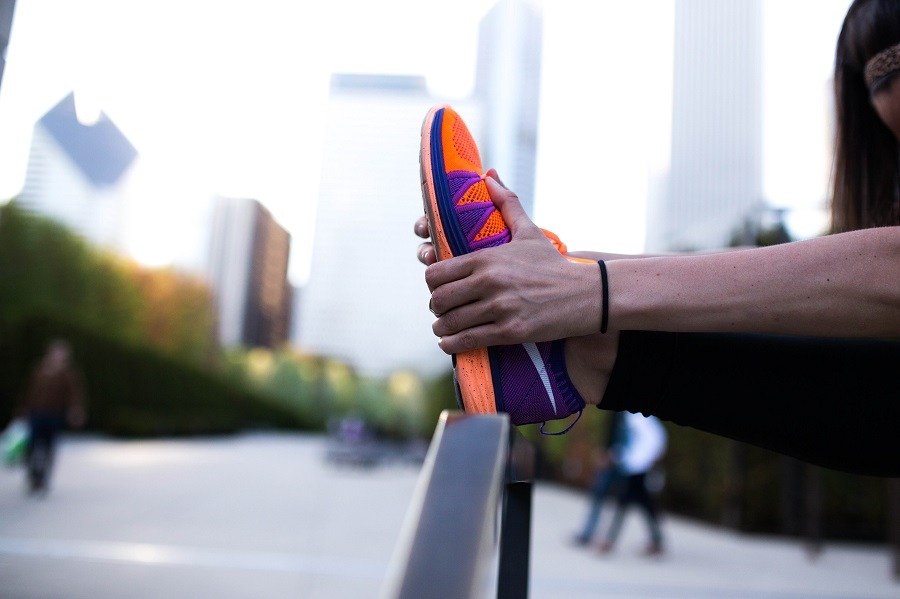 runner stretching his calf before race